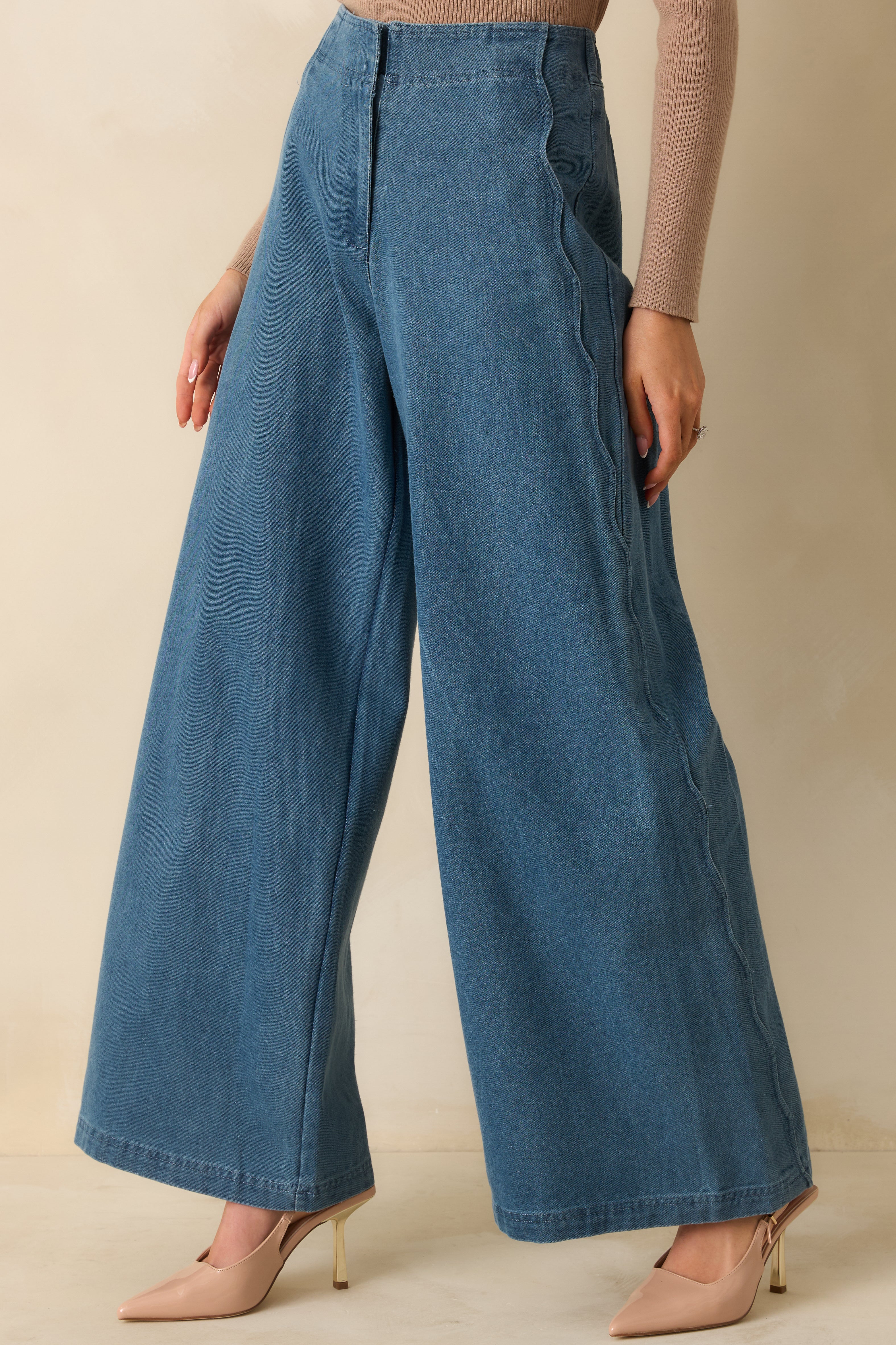 Cropped midsection view emphasizing the curved scalloped side seams for a modern detail.