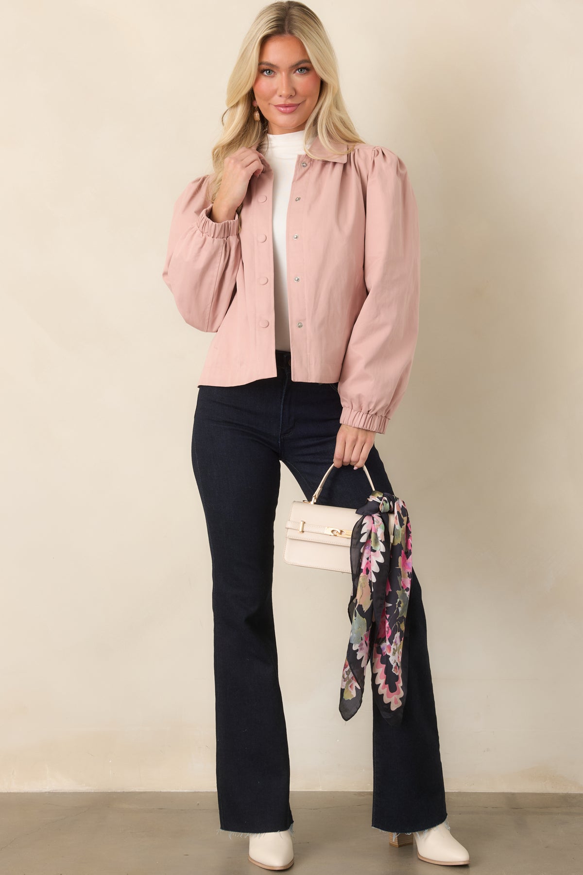 Cropped pink jacket showcasing its snap front closure, relaxed shape, and defined elasticized cuffs.