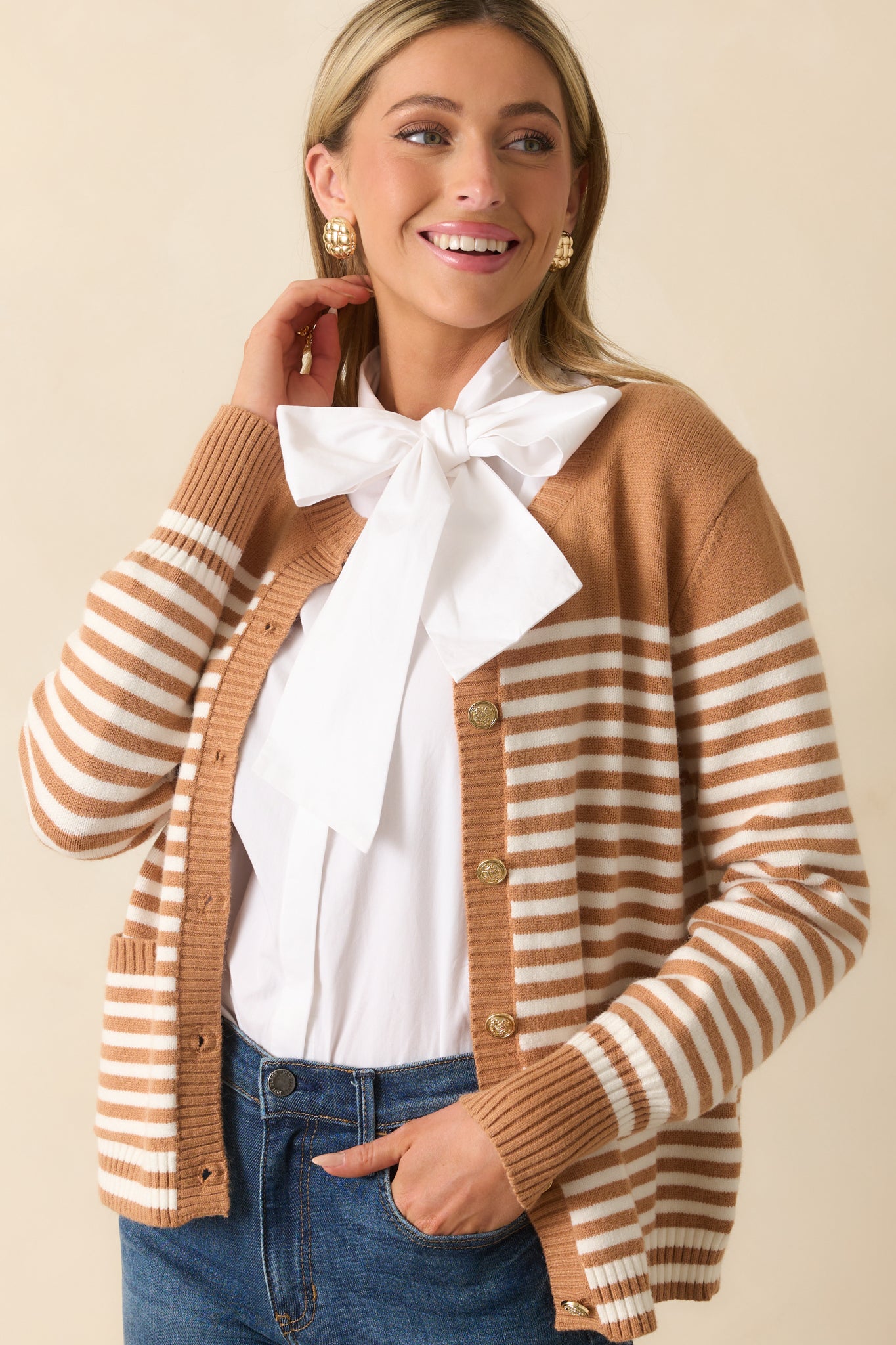 Cropped shot emphasizing the crew neckline, long sleeves, and relaxed fit of the striped cardigan.