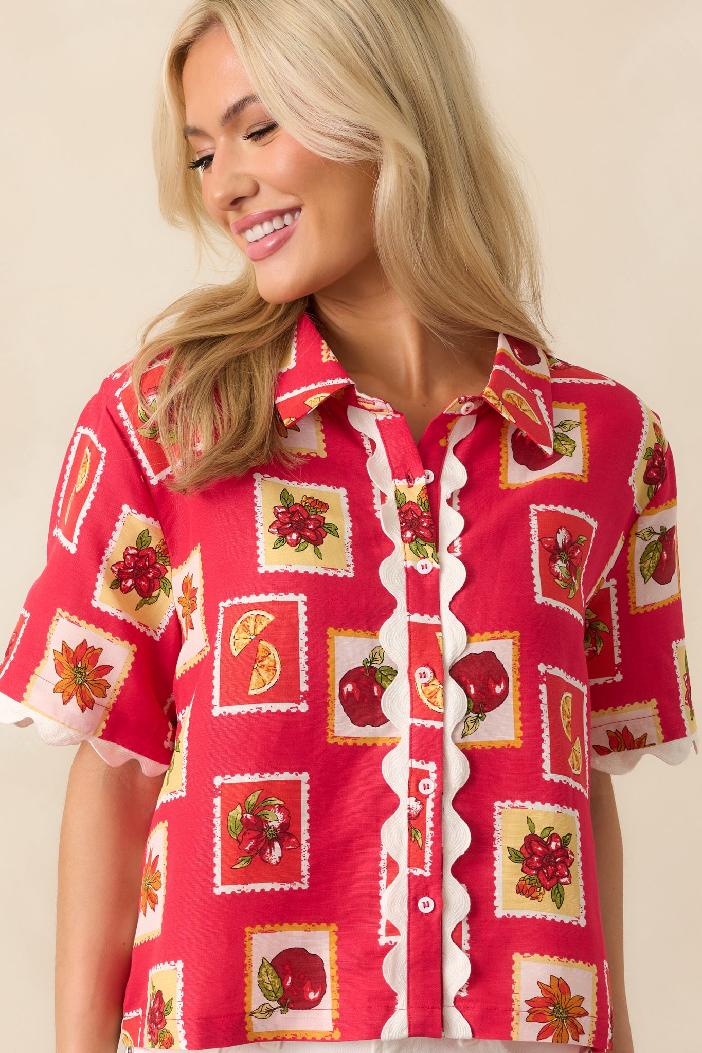 Cropped shot of the sleeve and shoulder area, emphasizing the floral and fruit motifs and the lightweight fabric texture.