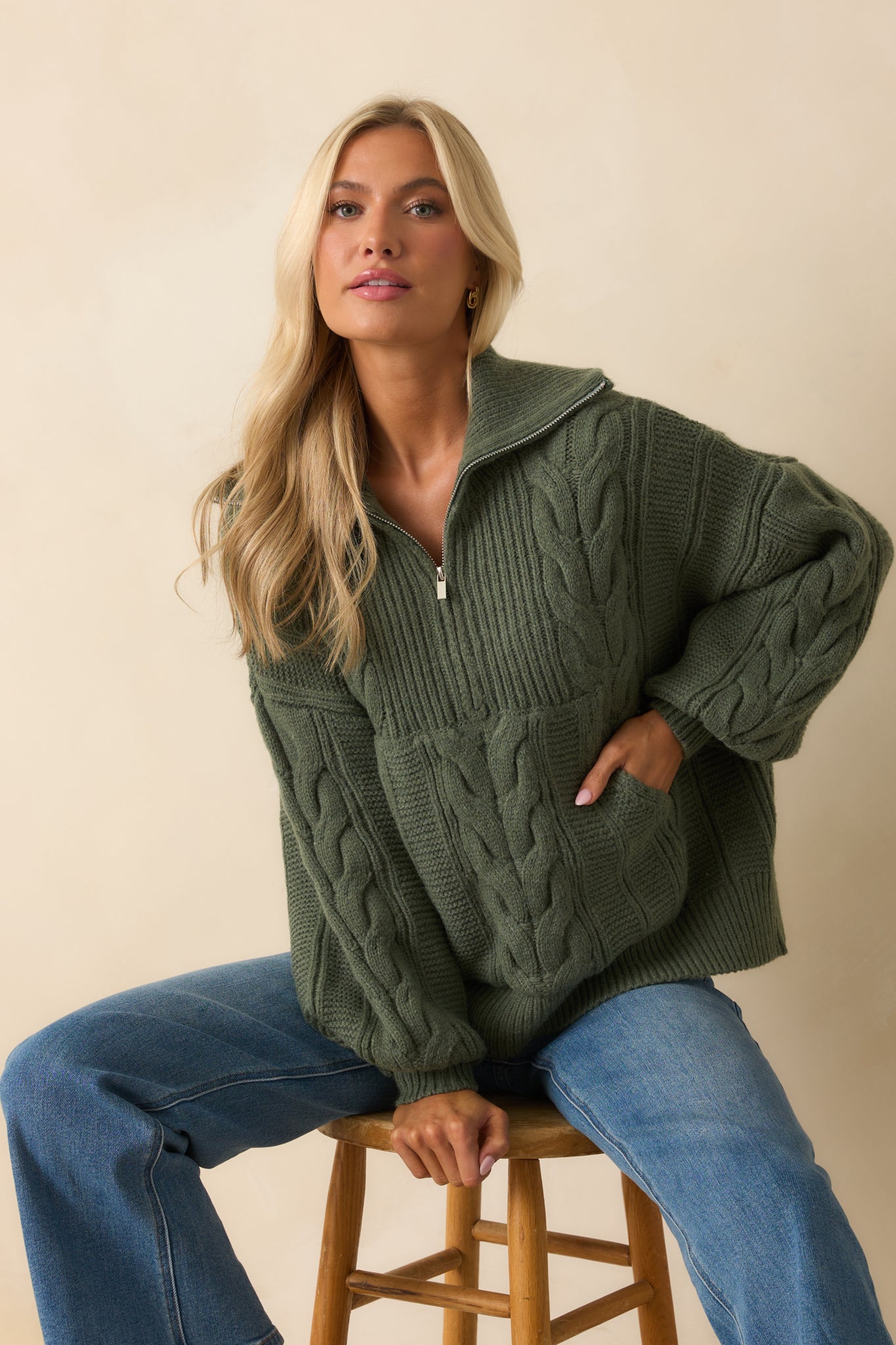 A cropped shot highlighting the kangaroo pocket and ribbed hem of the sweater.