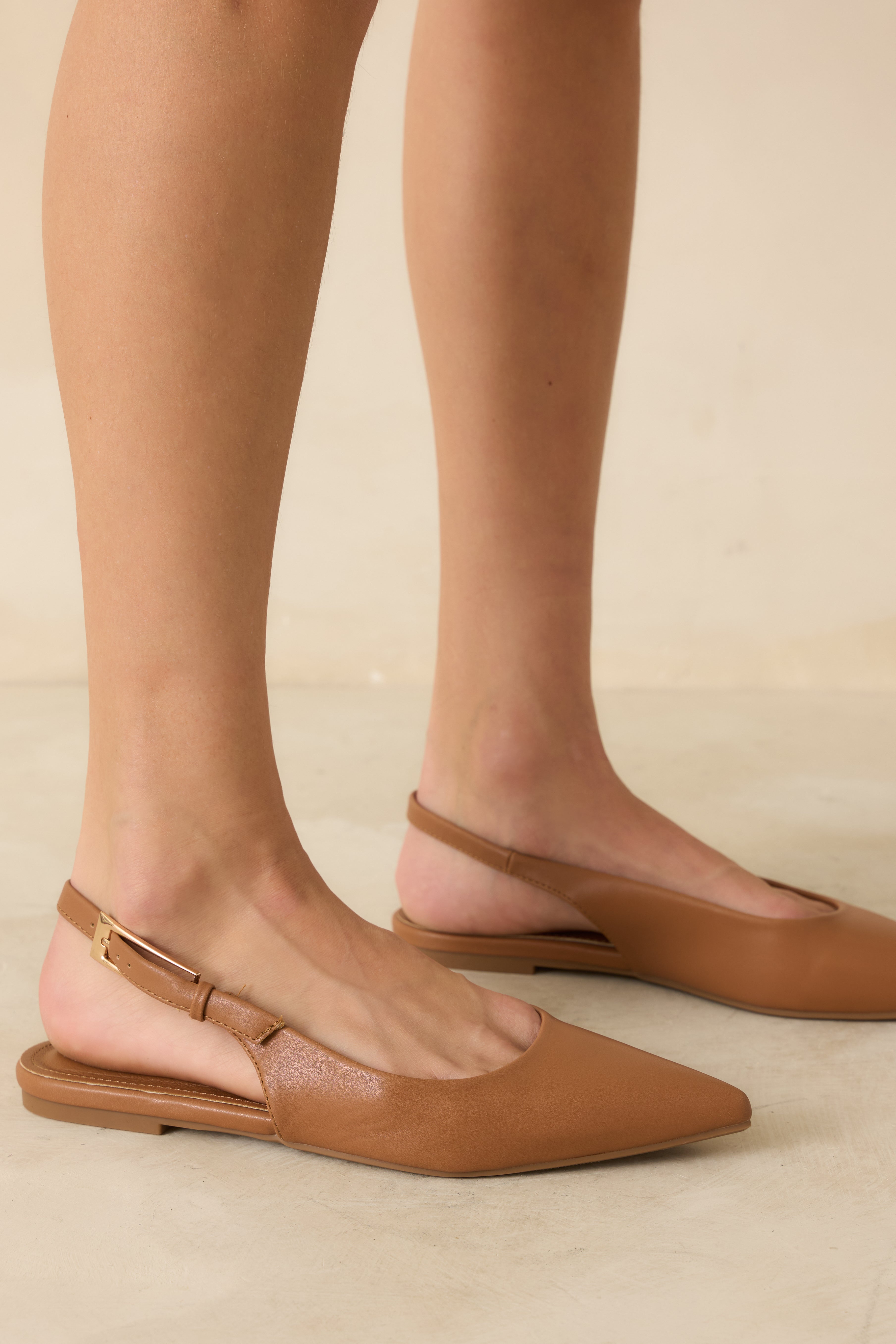 Cropped side view highlighting the adjustable buckle strap and closed heel of the flats.
