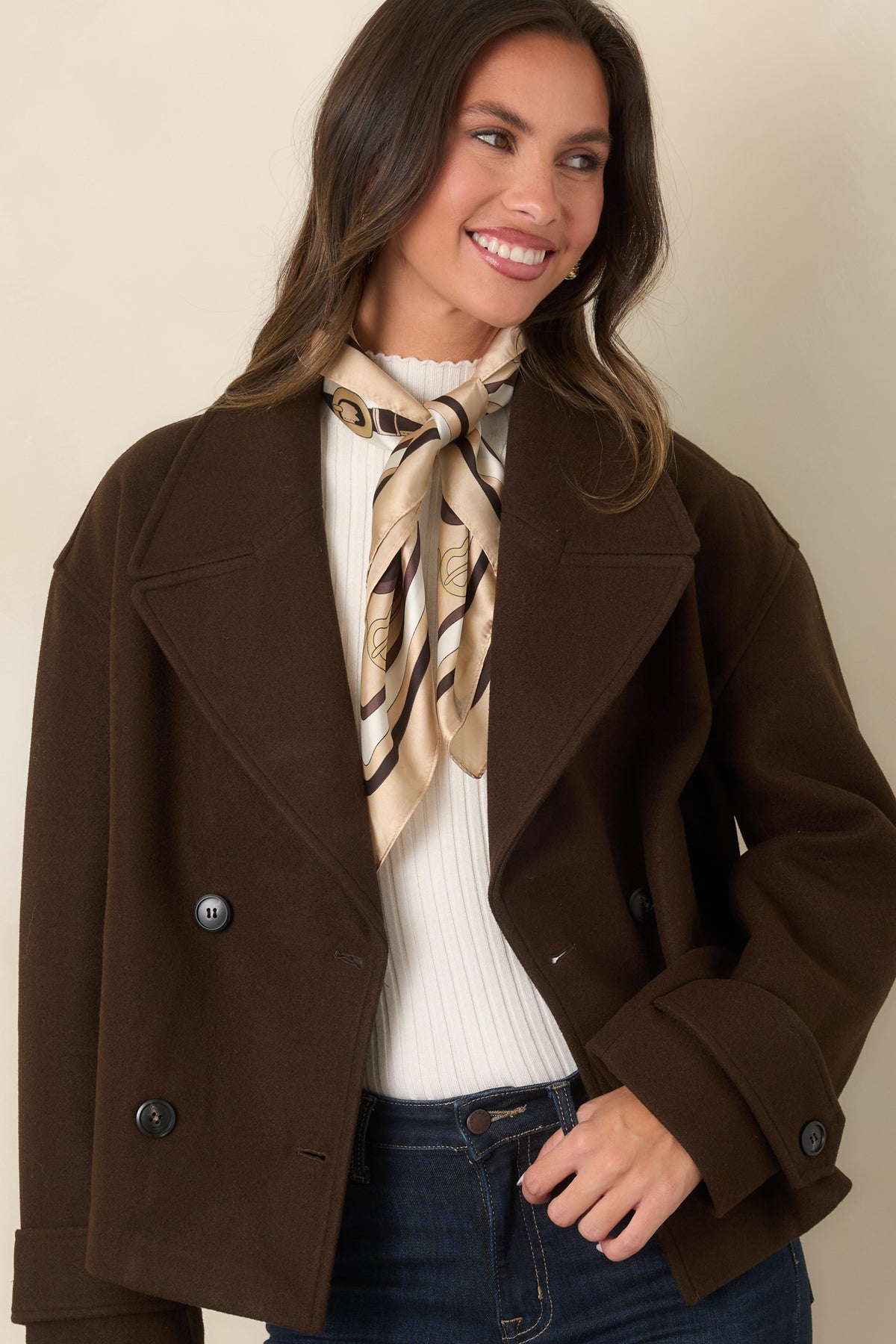  Brown cropped jacket with functional side pockets and a polished double-breasted front.