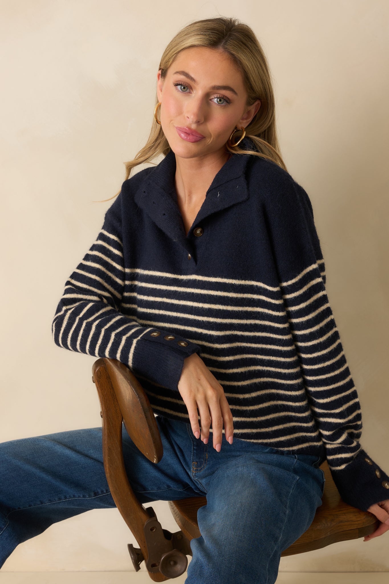 A cropped view showing the sleeve cuffs with functional buttons and horizontal stripe detail.
