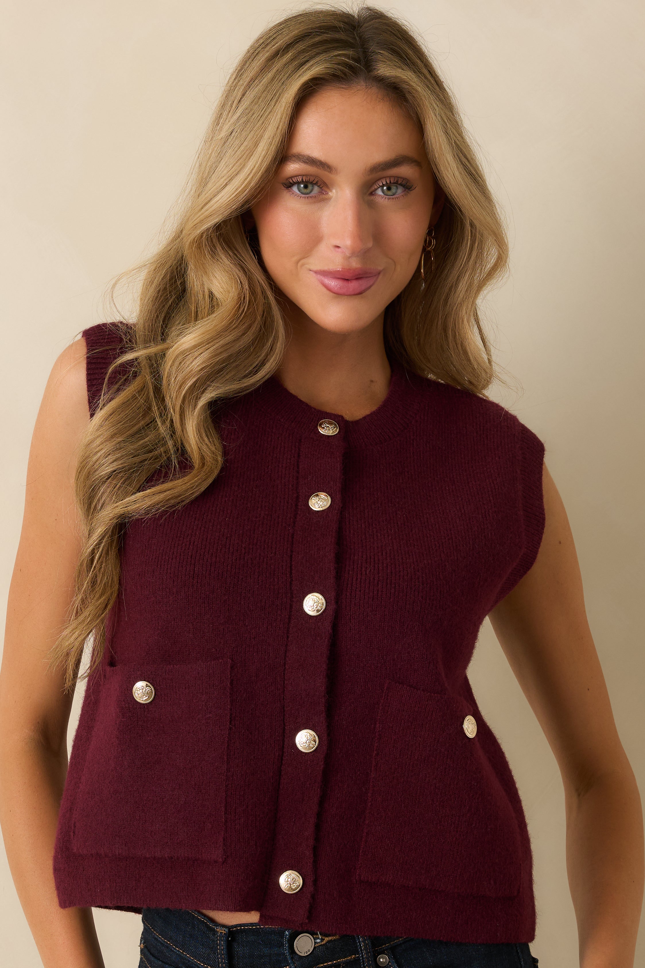 Cropped upper view focusing on the crew neckline and top buttons.