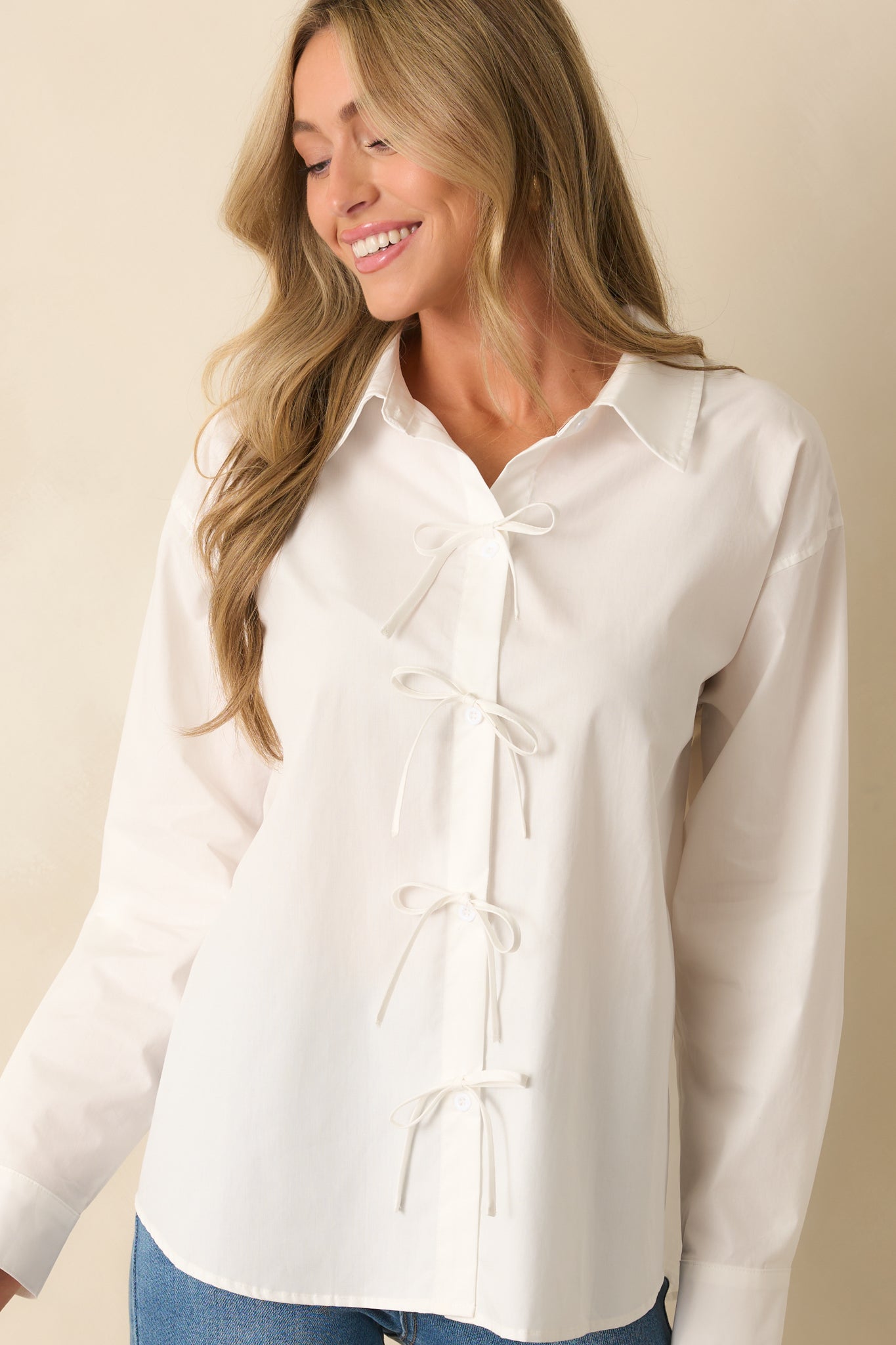A cropped view of the functional button front with white bow accents.