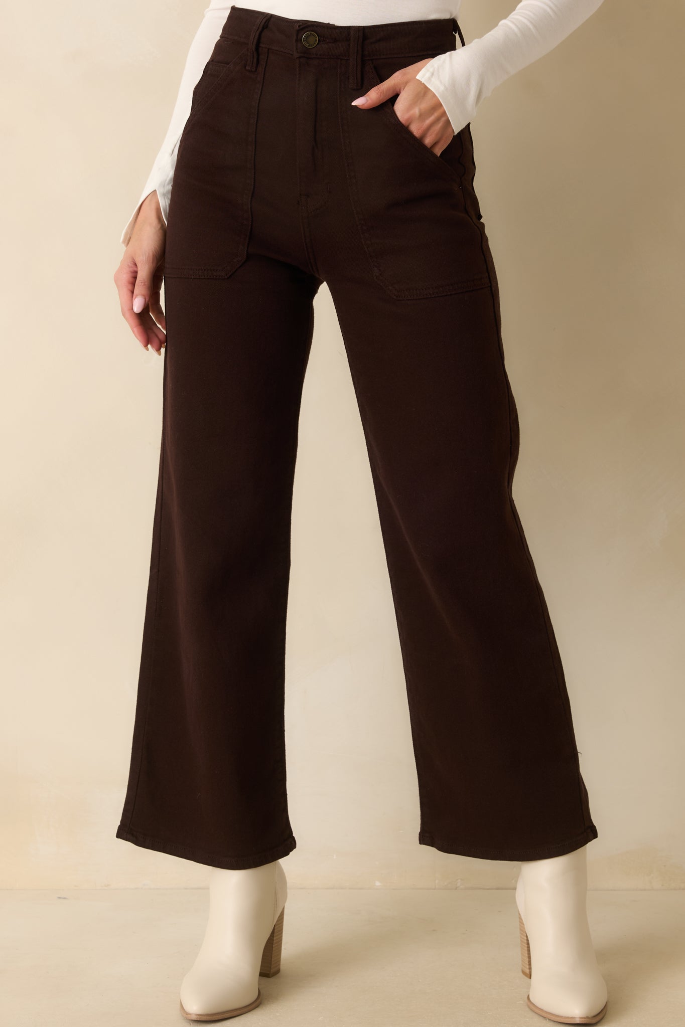 A cropped view focusing on the button zipper closure and belt loop detailing.