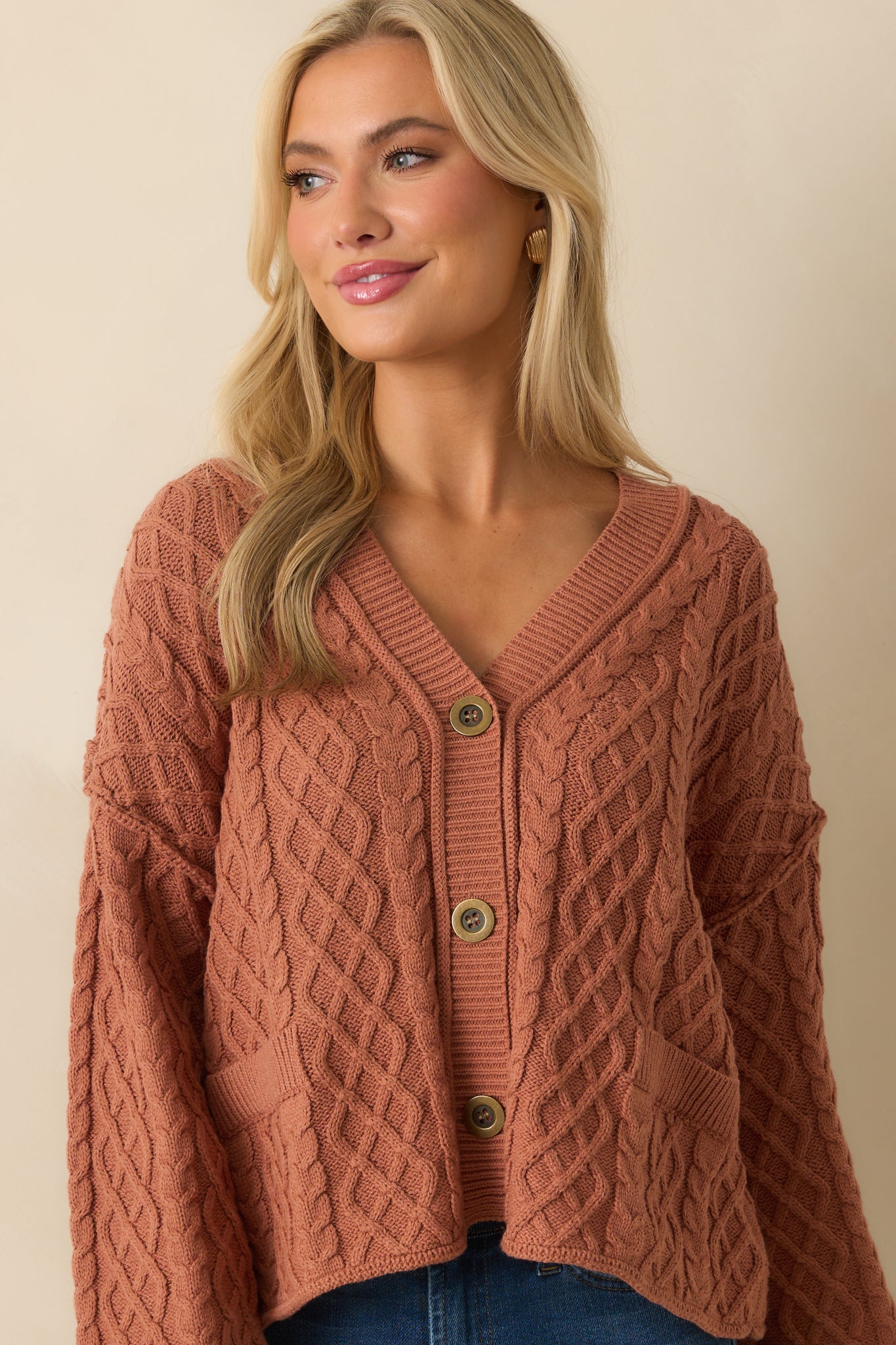 Another cropped view focusing on the cardigan's buttons and relaxed silhouette.