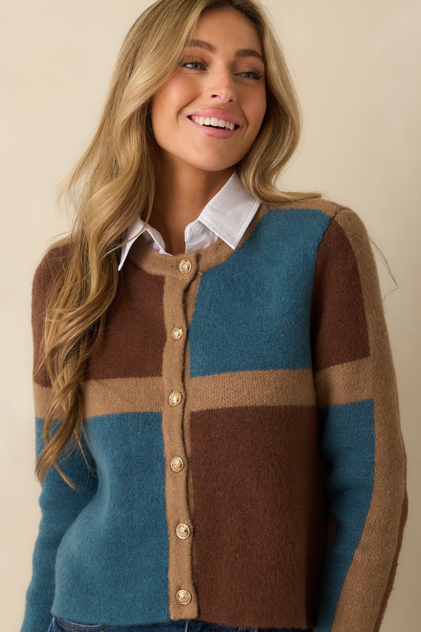 Cropped view emphasizing the gold-tone button closure and color block pattern.