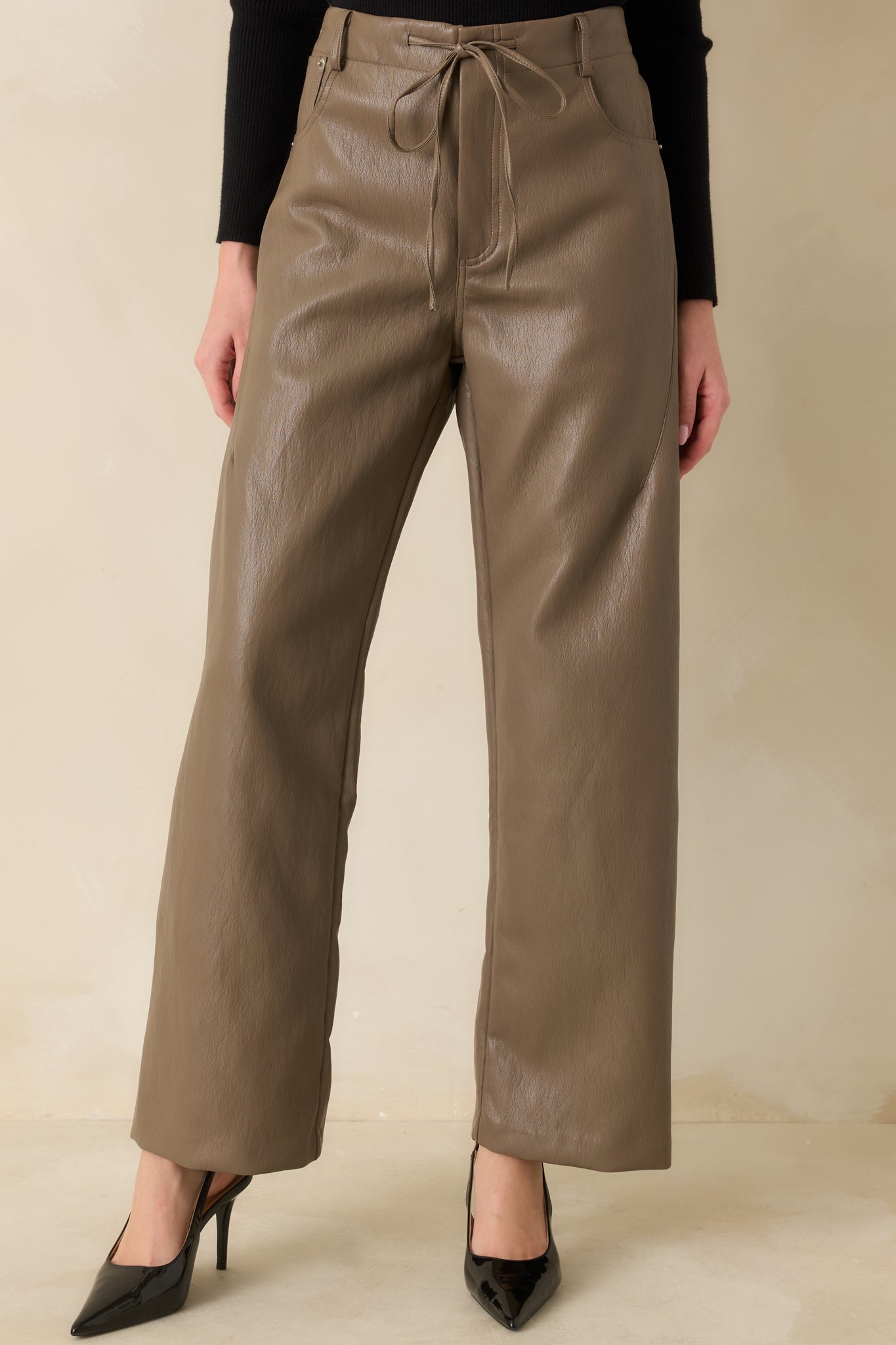 Cropped view highlighting the smooth faux leather texture and wide-leg shape.