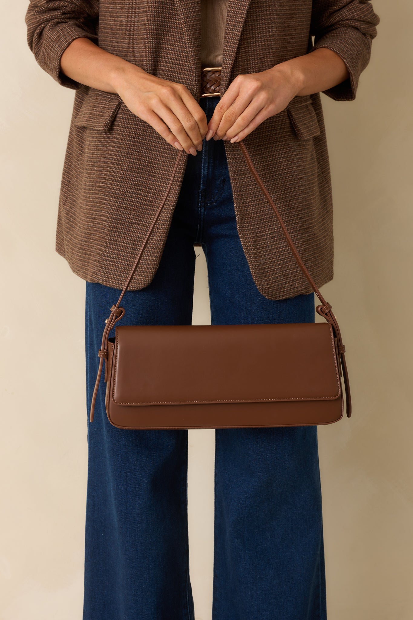 Cropped view focusing on the baguette body and adjustable shoulder strap attachment.