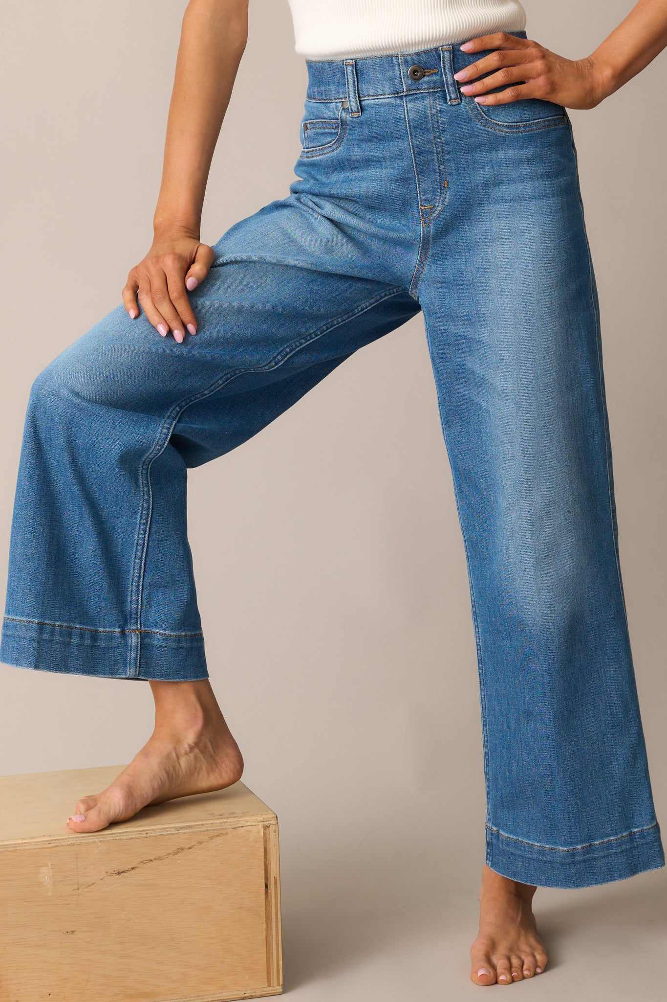 Cropped front view focusing on the faux pockets and waistband with visible stitching and a flat front finish.