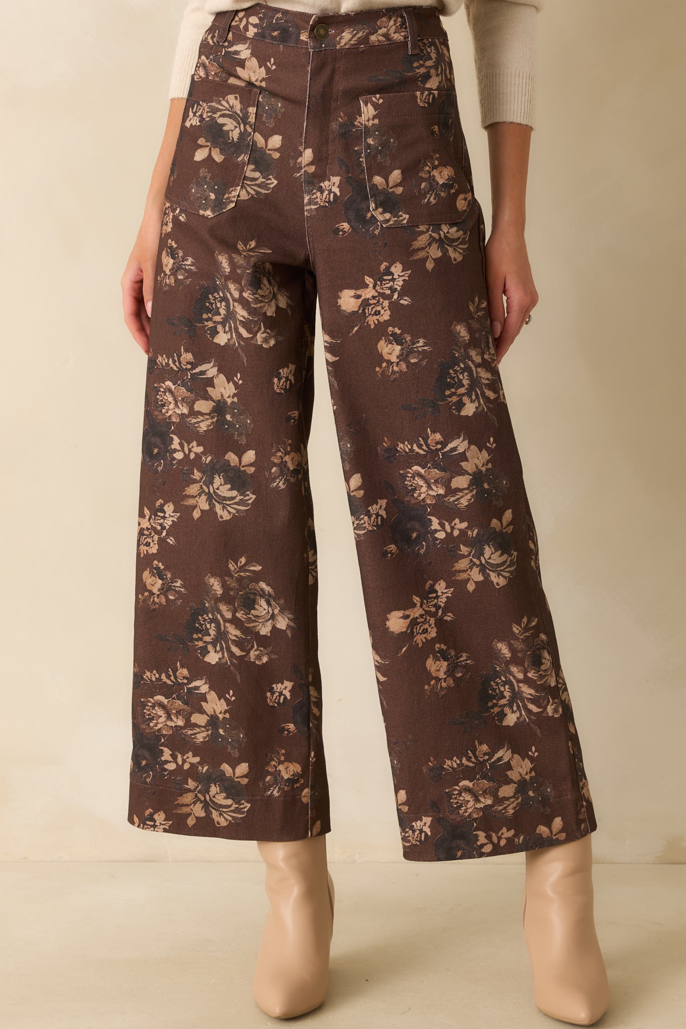 A cropped view focusing on the high-rise waist, belt loops, and button zipper closure.