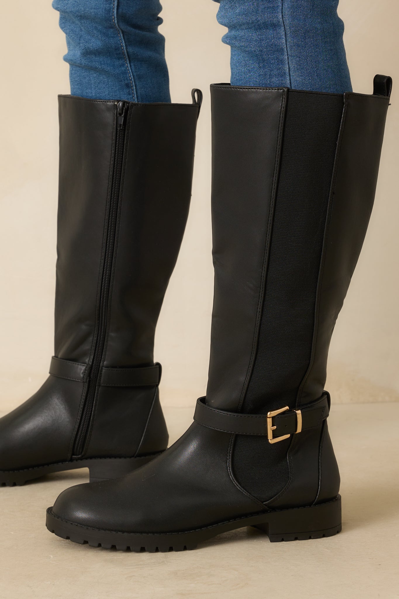 Cropped front view highlighting elastic side panel and low block heel.