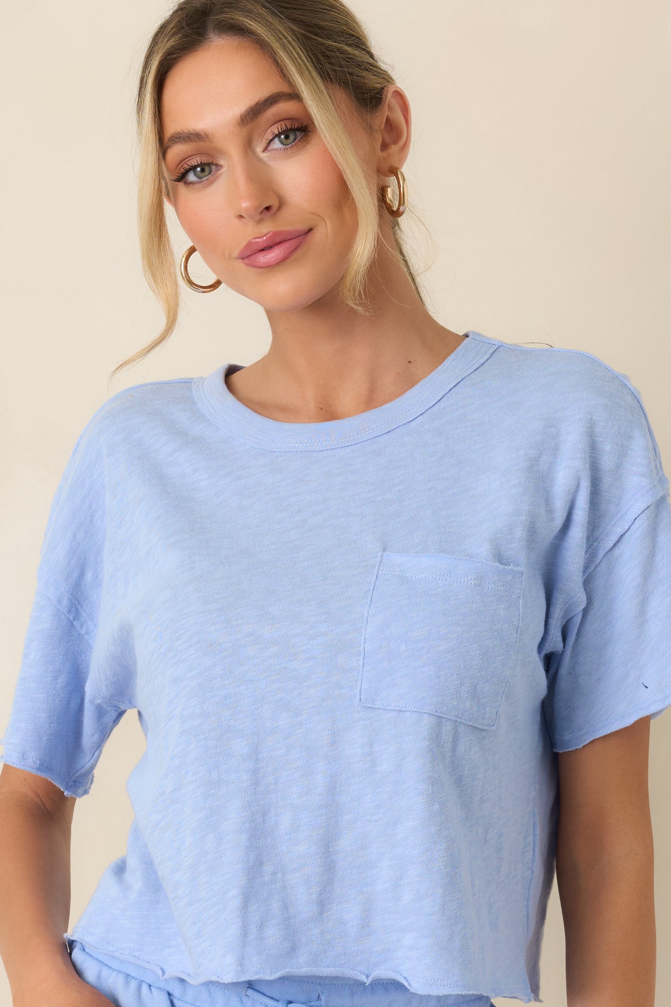 Cropped view of the light blue tee emphasizing the lightweight, breathable material and easy drape.