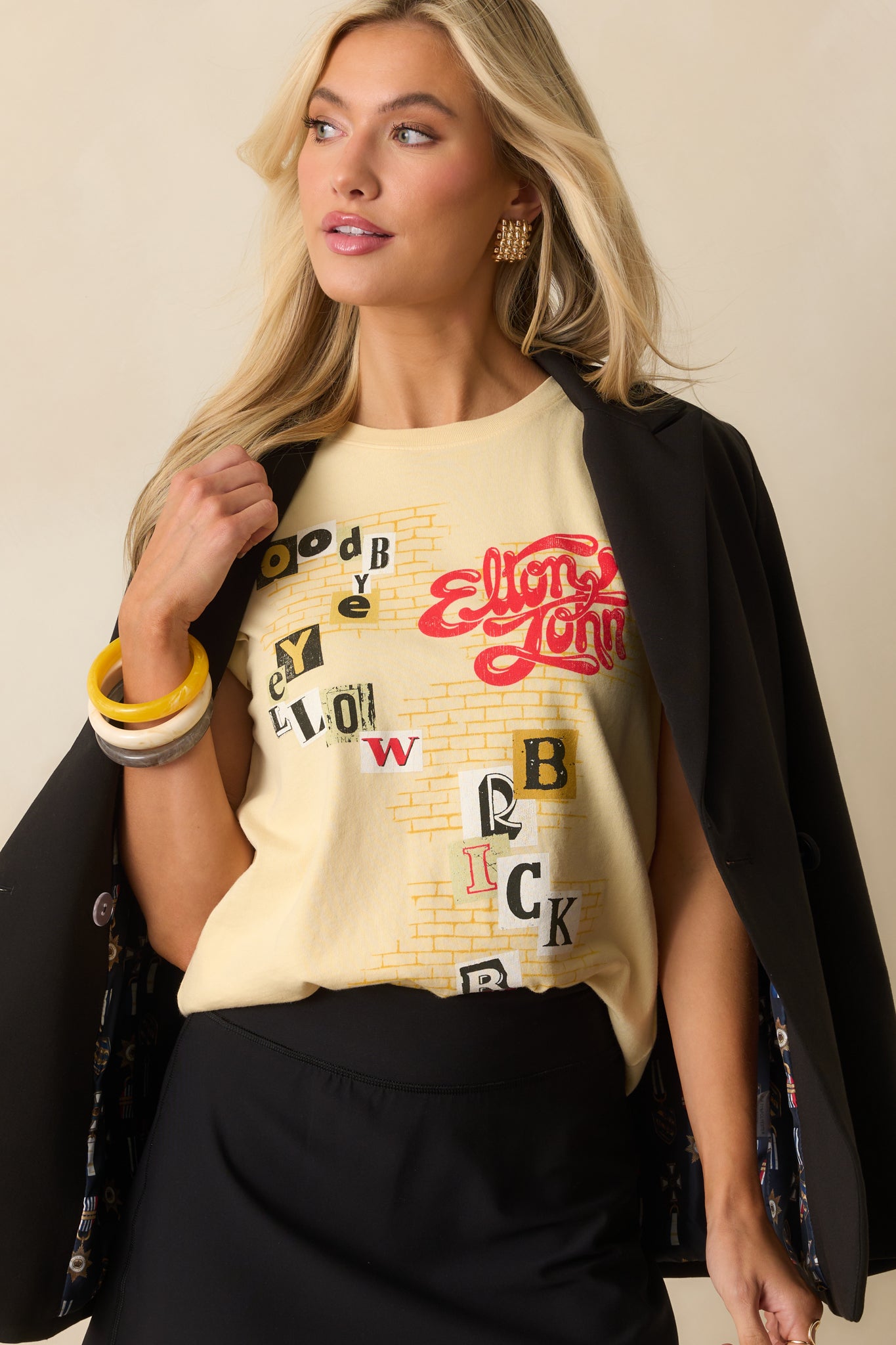 Cropped image highlighting the neckline and soft butter yellow color.