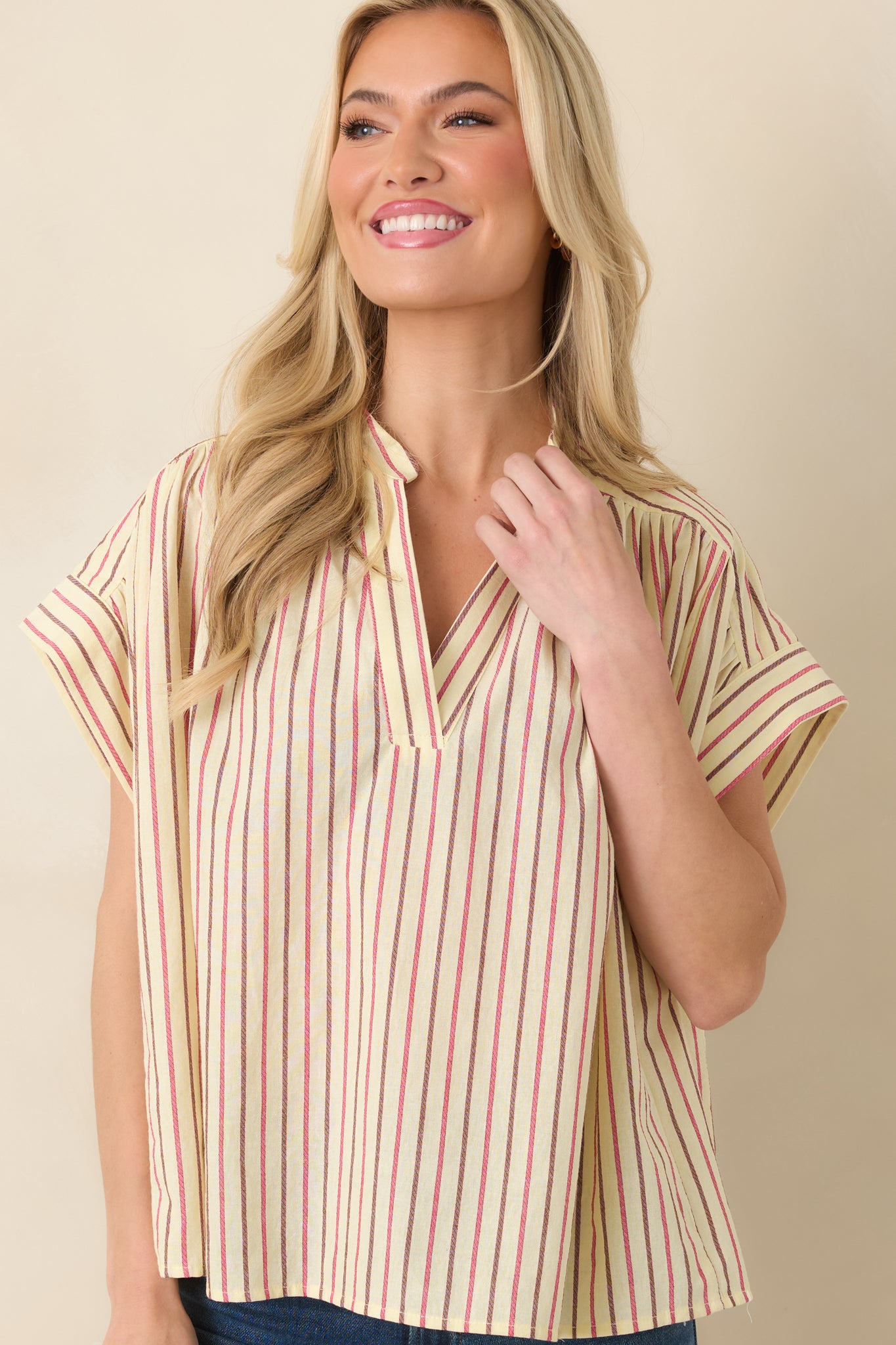 Cropped view of dolman-style short sleeves and relaxed drape.