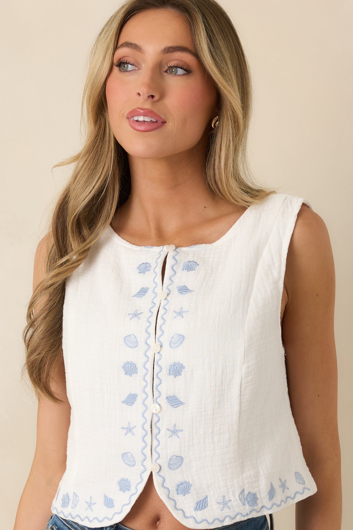 Cropped view of ivory tank showing relaxed fit and clean neckline.
