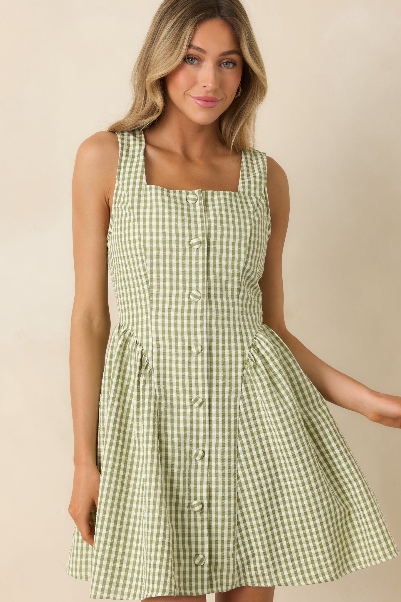 Cropped view of mini dress featuring pocket detail and lightweight fabric texture.