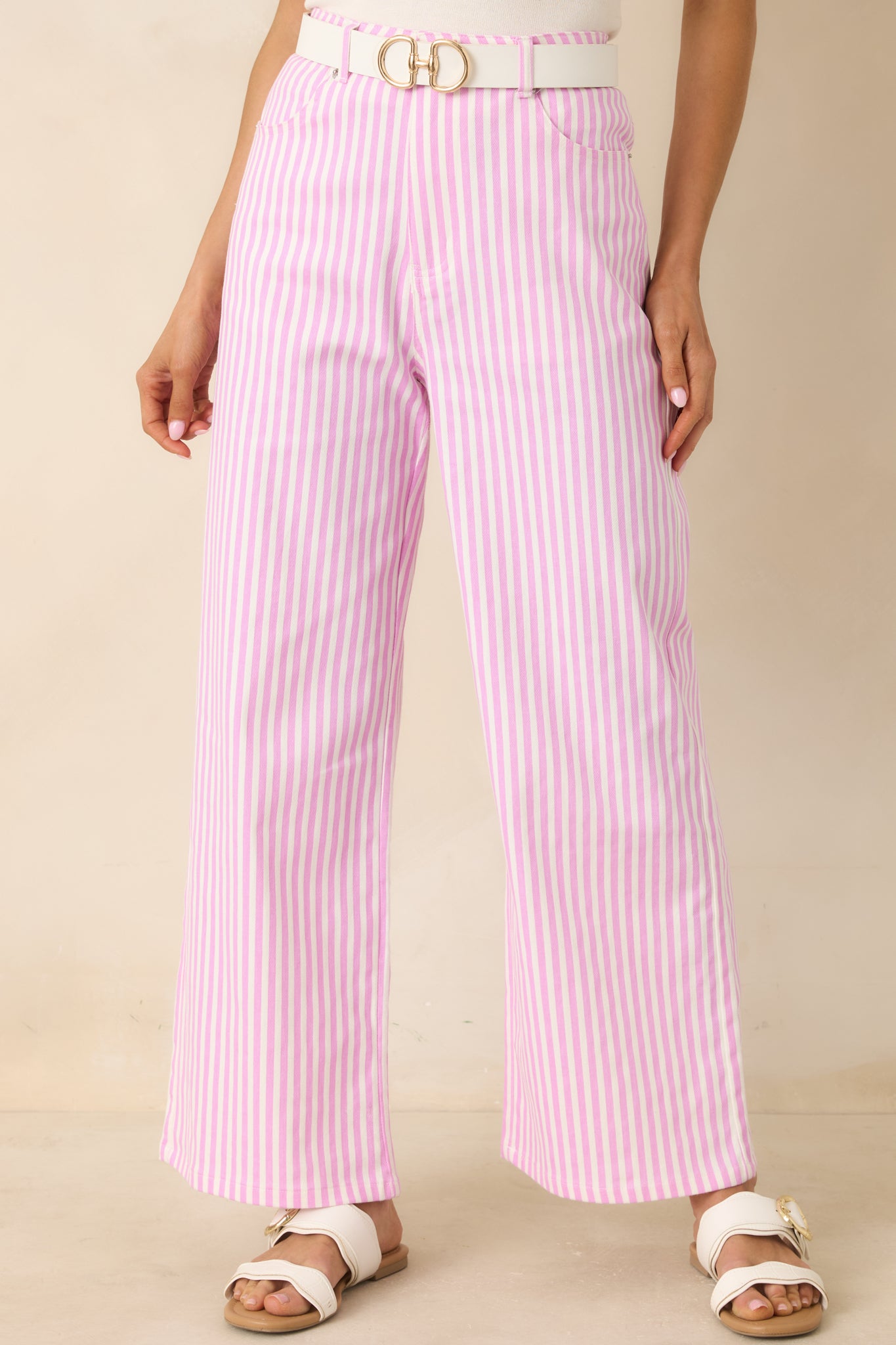 Cropped view of vibrant striped trousers with crisp, structured silhouette.