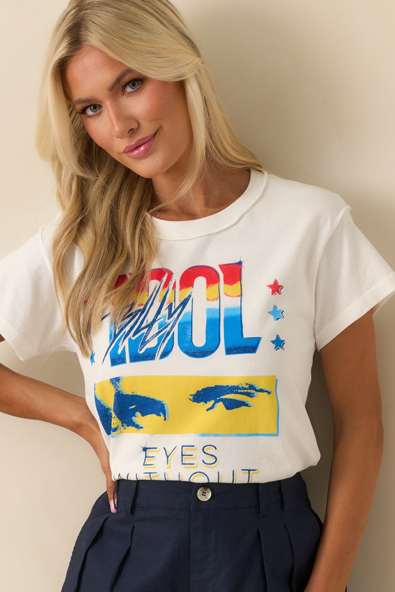 Cropped upper view focusing on the crew neckline and raw-edged reverse seam running along the shoulder.