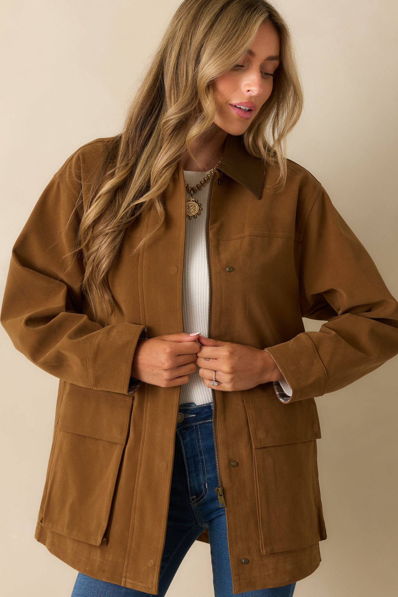 Cropped view emphasizing the large patch pockets and structured jacket fit.