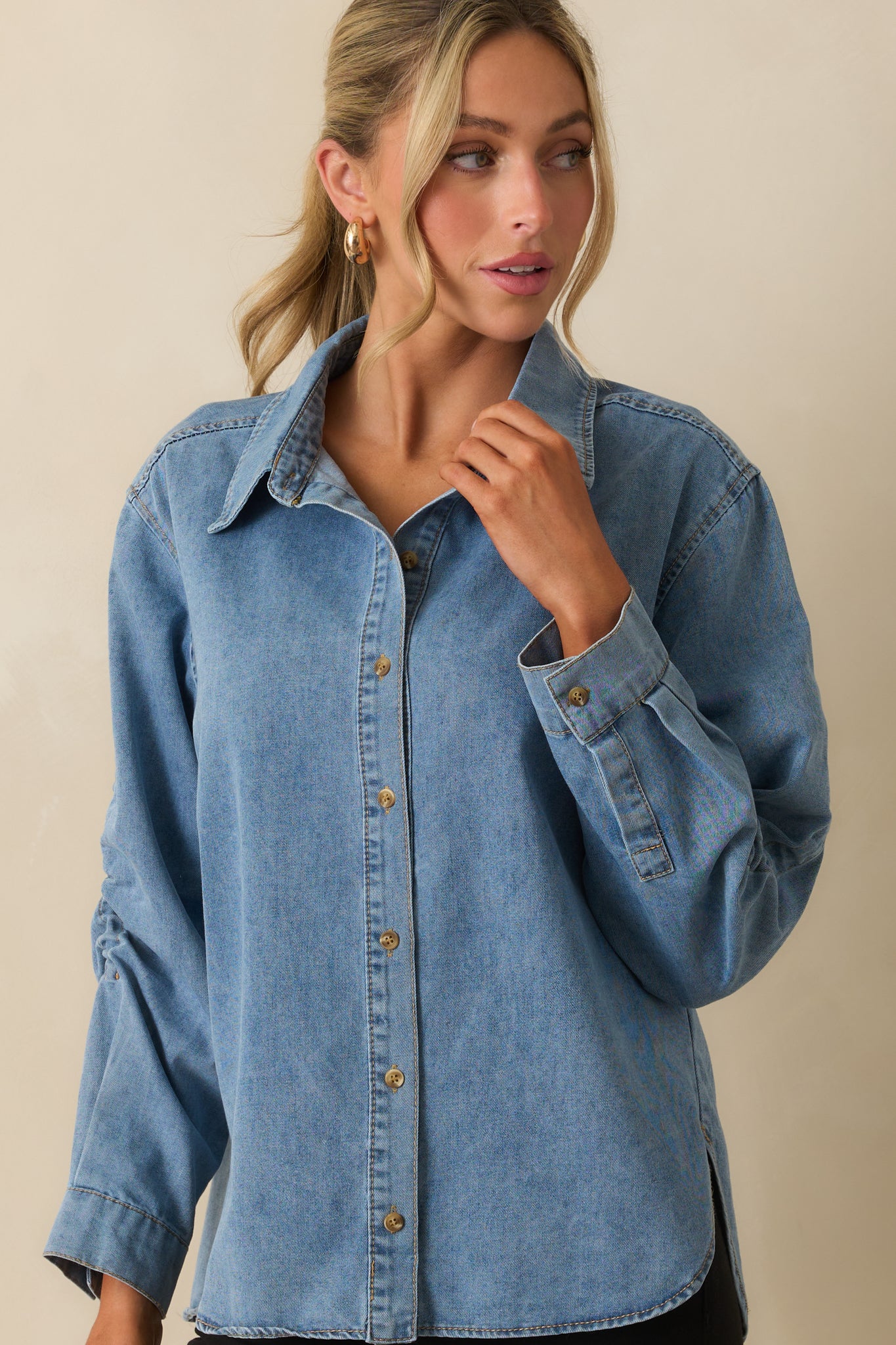 Cropped view highlighting the scoop hemline and front denim texture.