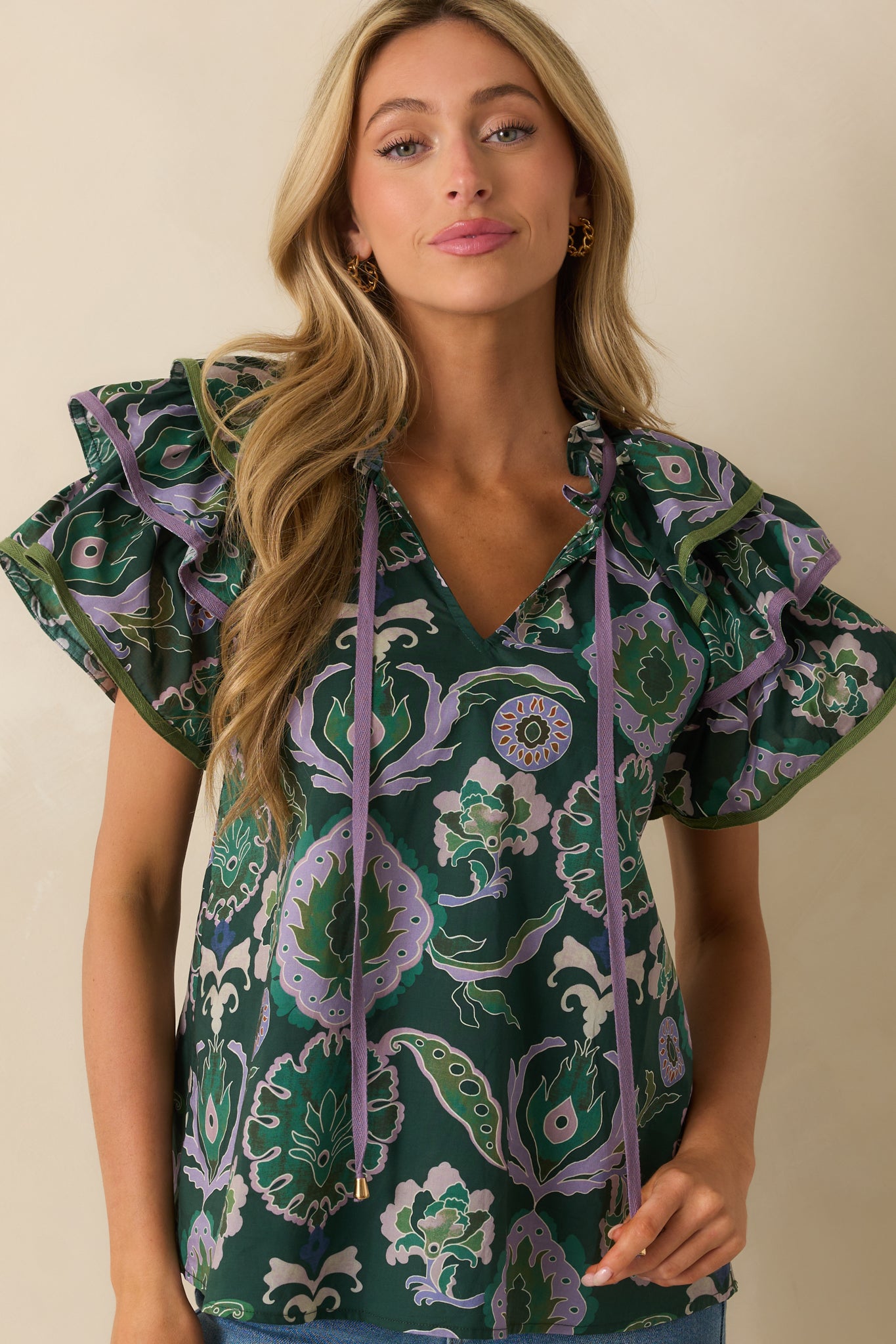 Cropped view of sleeves, highlighting short ruffle detail and print pattern.