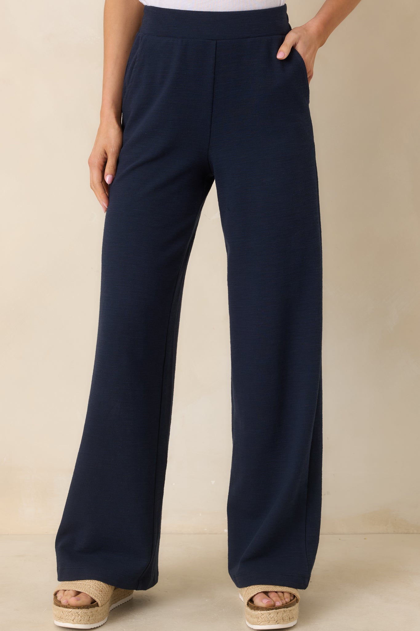 Cropped front view highlighting the elastic waistband and streamlined wide-leg silhouette.