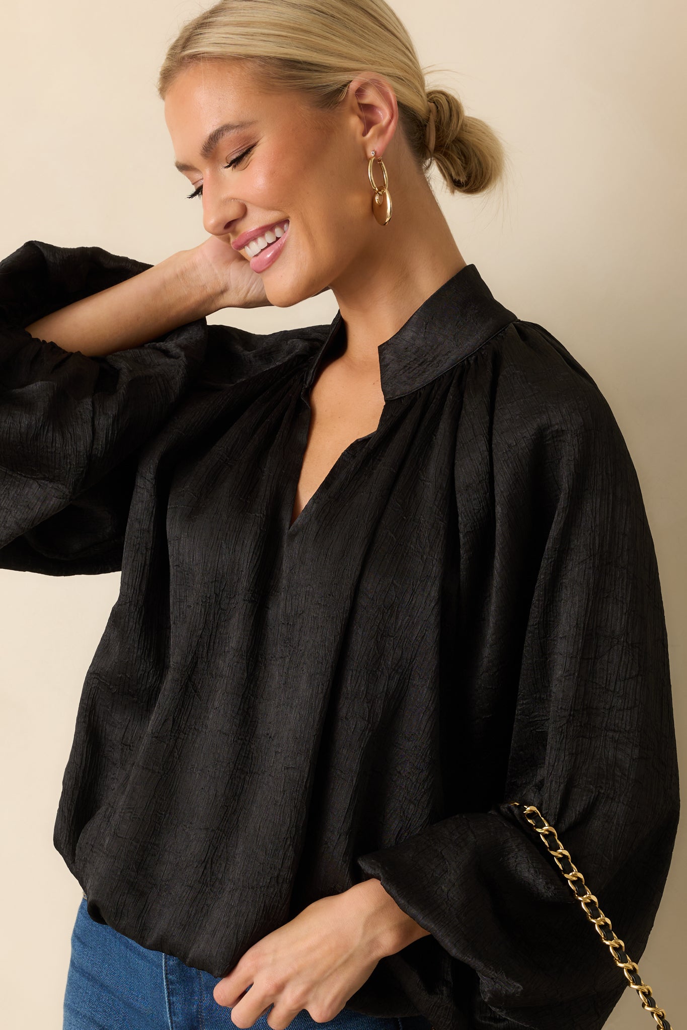 Cropped view emphasizing the V-neck shape and silky satin finish.