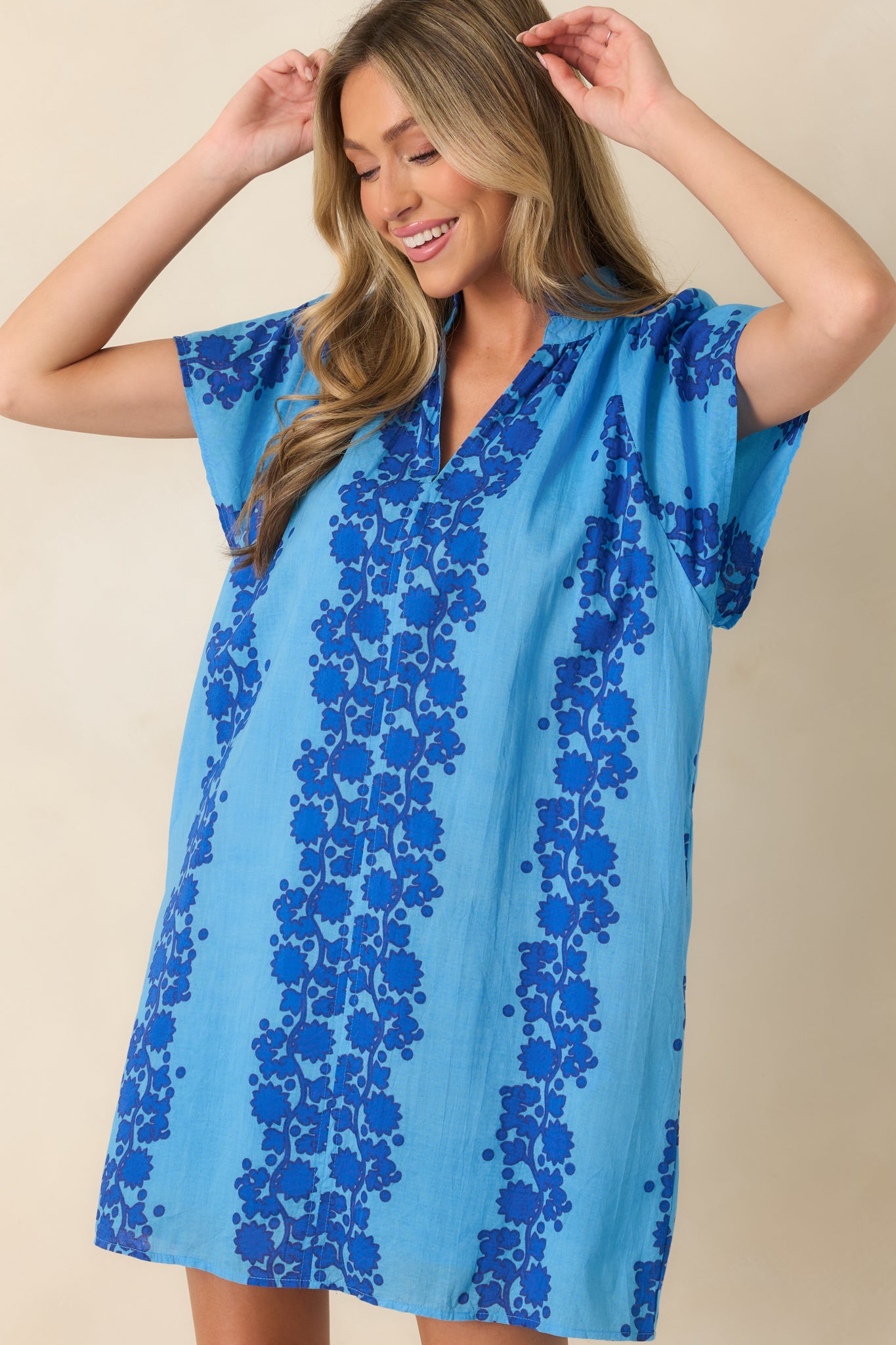 Detailed view of the dark blue floral print against the light blue cotton fabric.