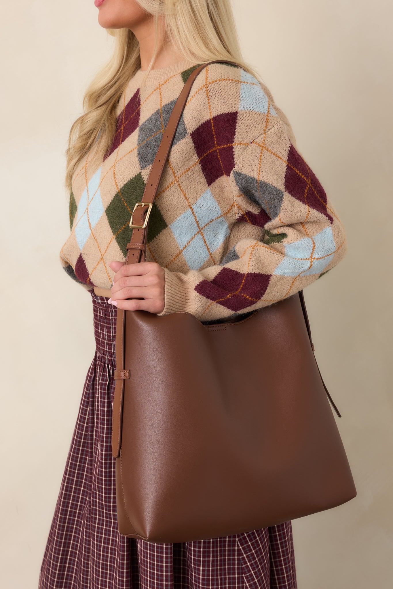 Rich dark brown handbag featuring a roomy interior, adjustable shoulder strap, secure magnetic closure, and versatile everyday carryall design.