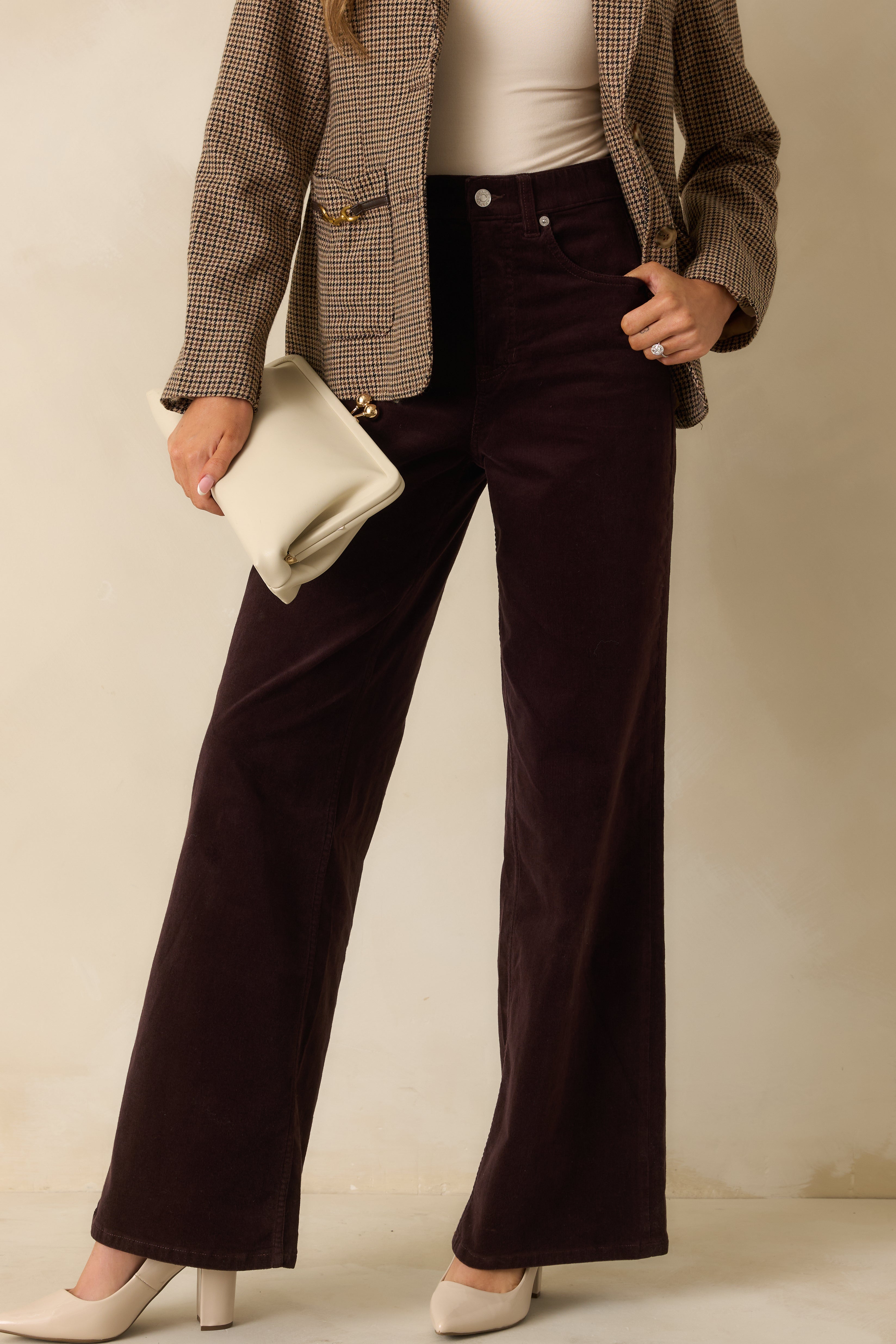 Dark brown corduroy jeans highlighting the soft ribbed texture and structured wide-leg shape for a classic look.
