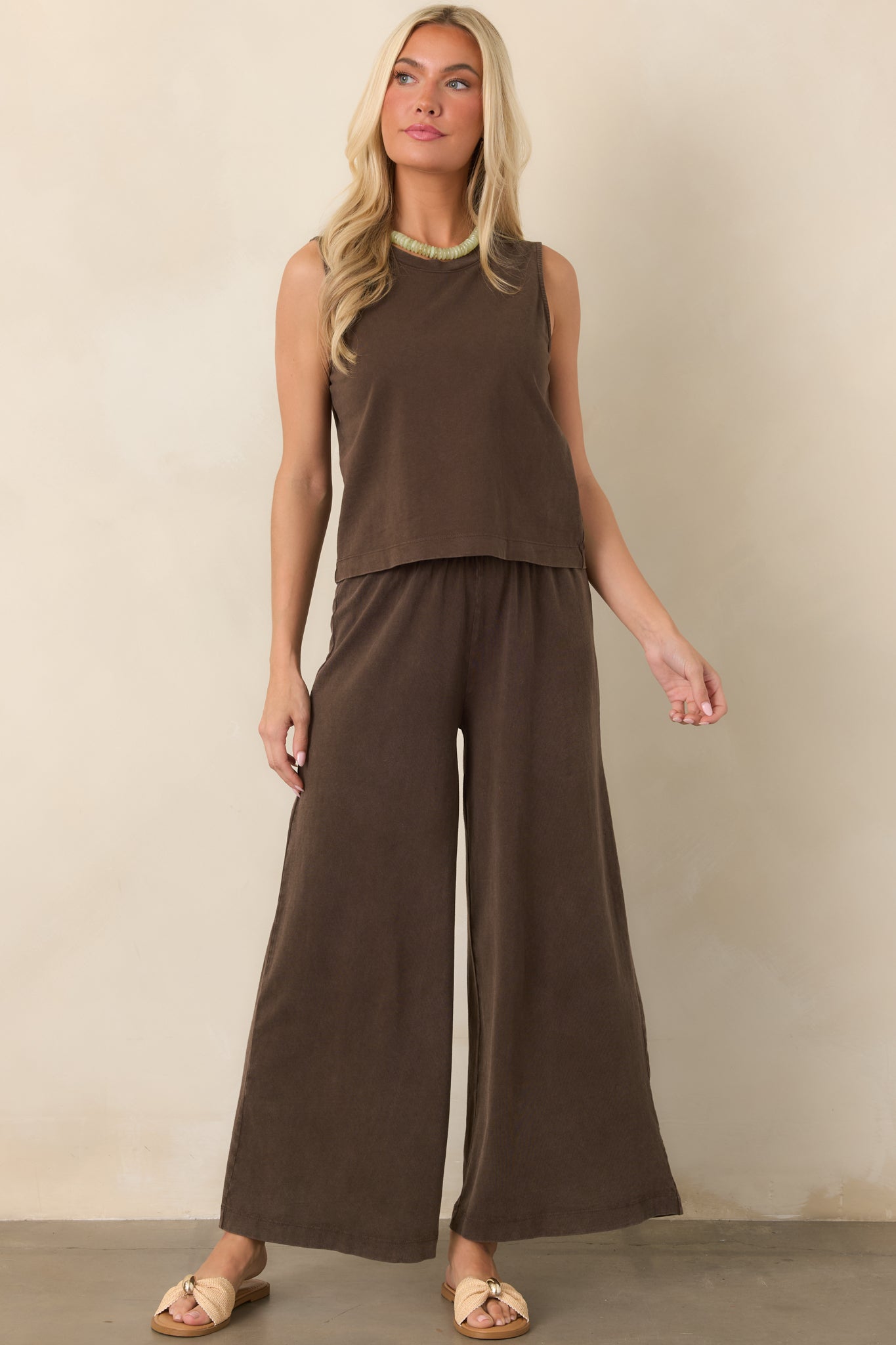 Dark brown relaxed pants featuring a comfortable elastic waist and flowing wide legs with an effortless silhouette.