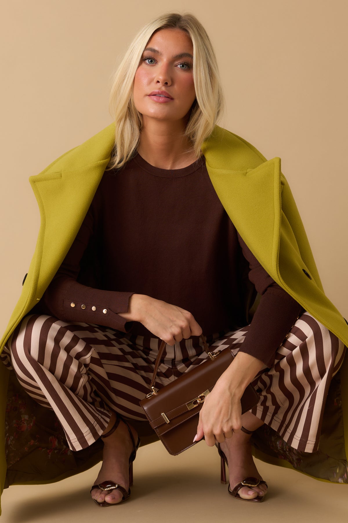 Dark Brown Top Featuring a Crew Neckline, Straight Silhouette, and Long Sleeves.