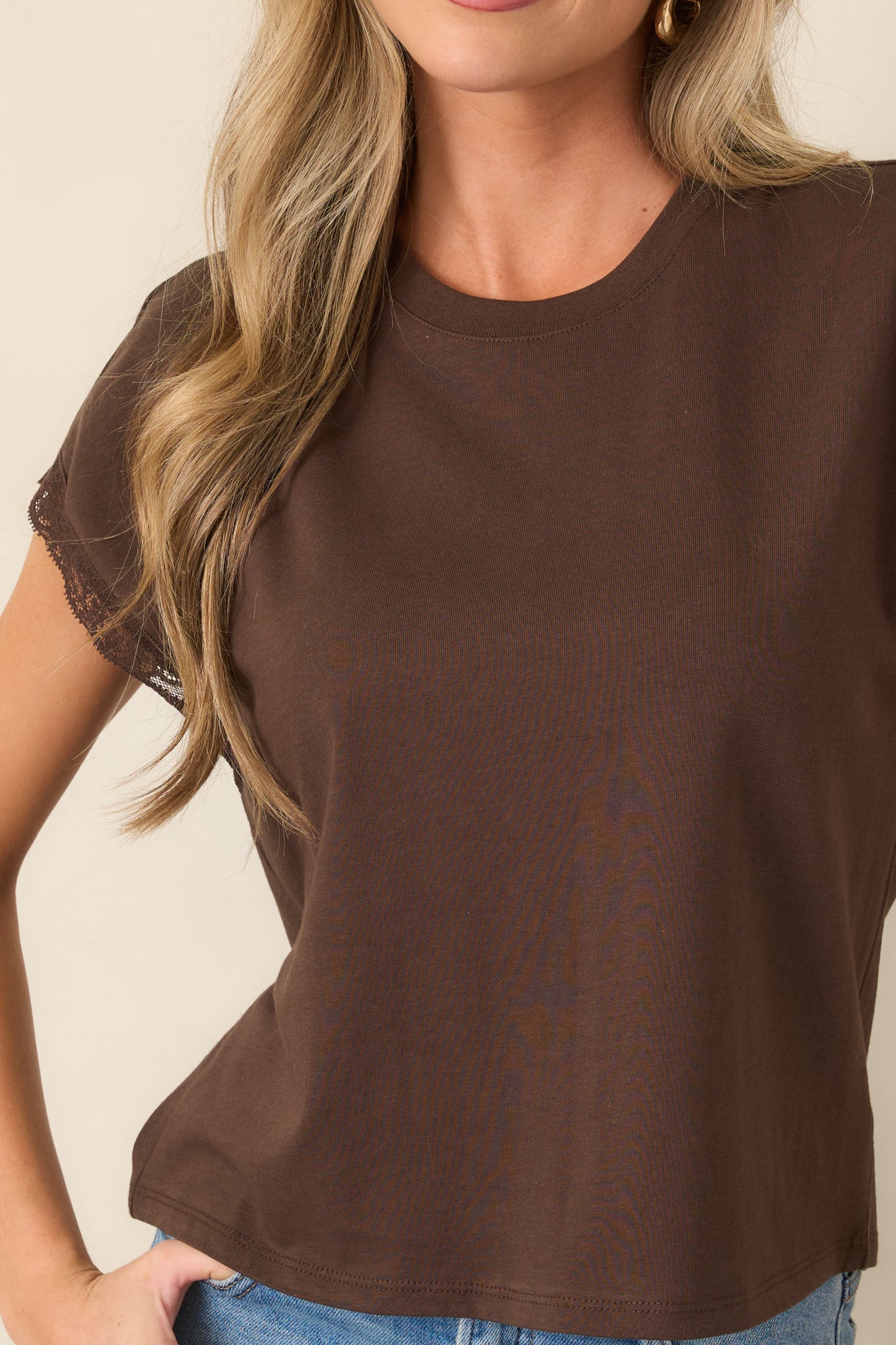 Close-up highlights the smooth cotton-lyocell texture, crew neckline, and delicate lace trim along the cap-style sleeves.