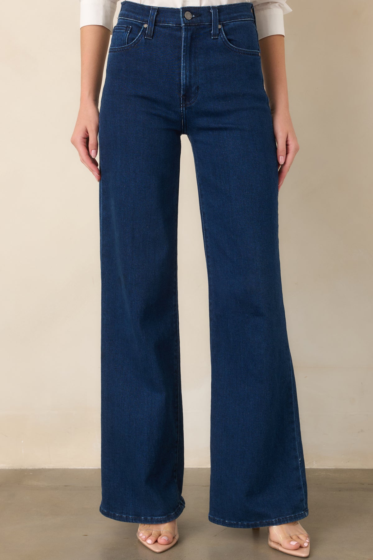 Dark denim close view emphasizing the generous width of the leg and smooth construction of the wide-leg silhouette.