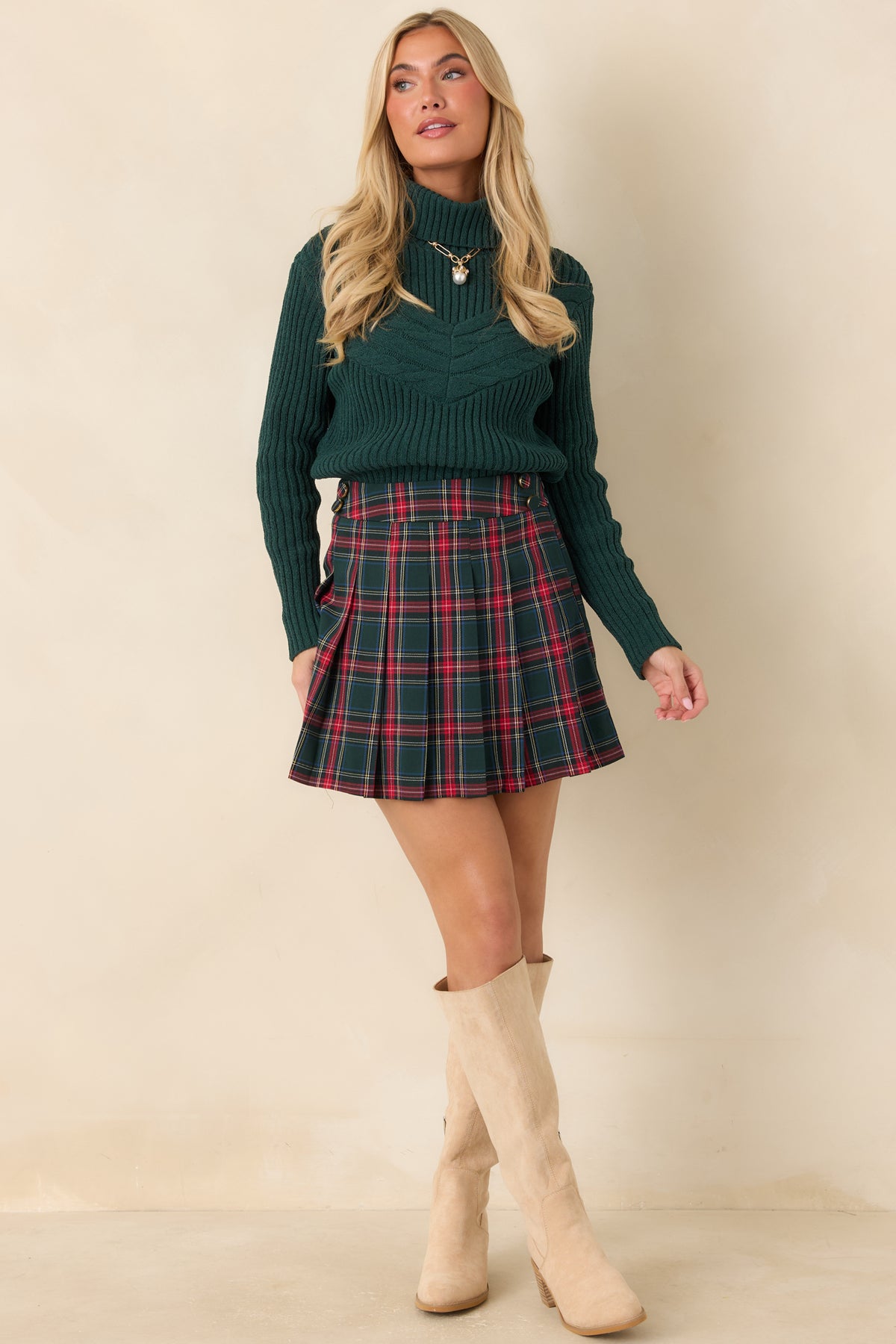 Dark green ribbed pullover with dropped shoulders, long sleeves, and textured chevron cable patterns.