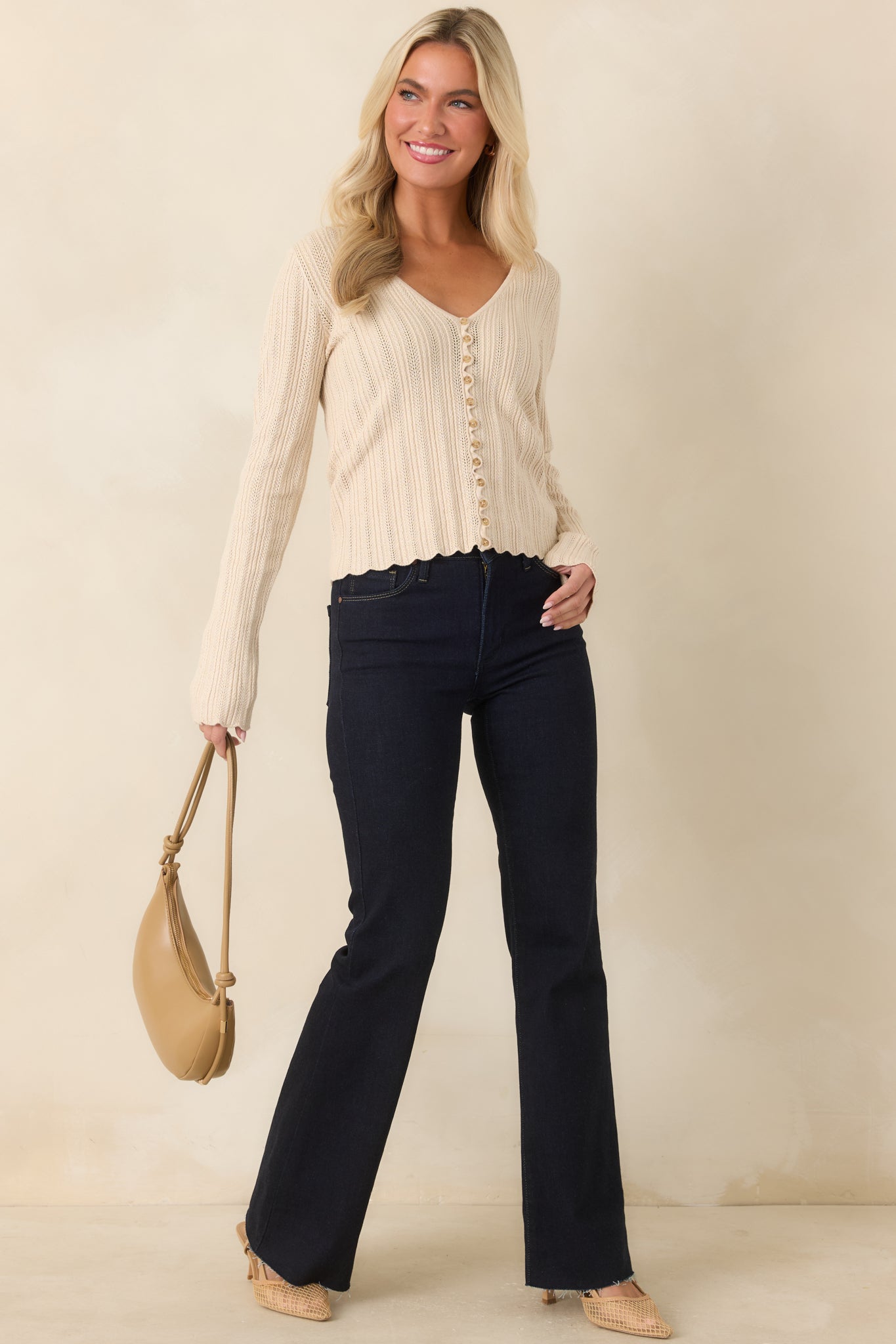 Dark indigo flare jeans featuring a high-rise waist, fitted hips, and a dramatic wide flared leg.