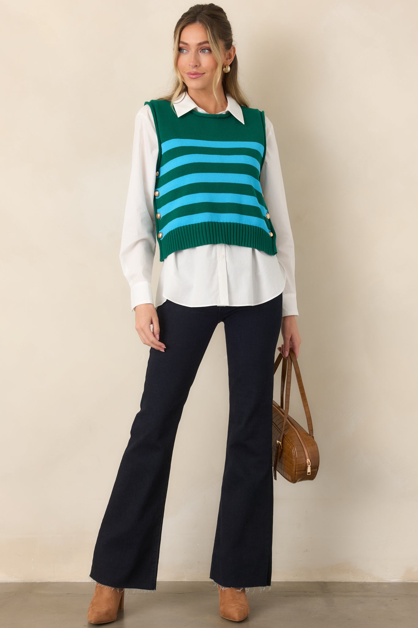 Dark indigo stretch jeans featuring a high-rise waist, fitted hips and thighs, dramatic flared legs, belt loops, and classic five-pocket styling.