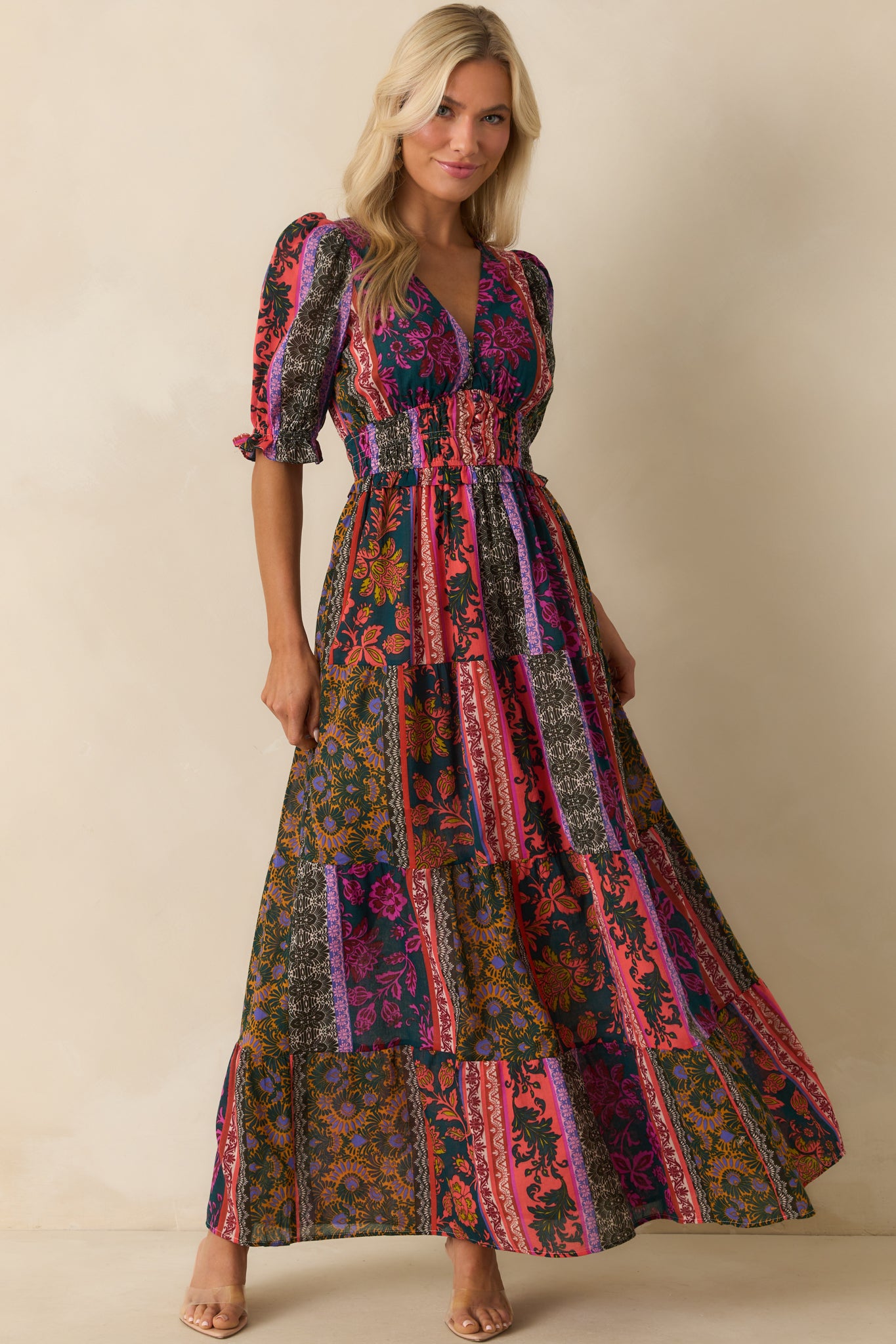 Dark teal maxi dress with a multicolor patchwork print and V-neckline.