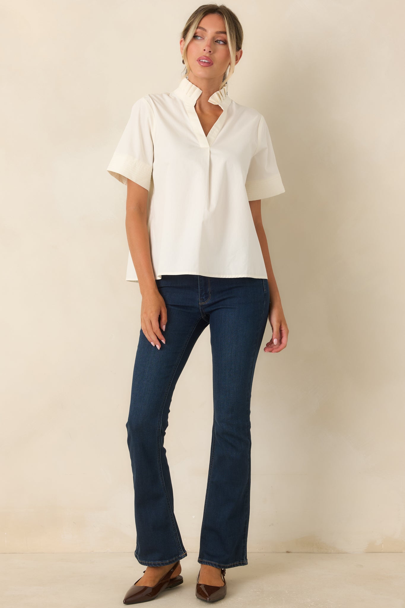 Dark wash cotton blend jeans showcasing a slight flare leg, full-length design, and classic everyday styling.