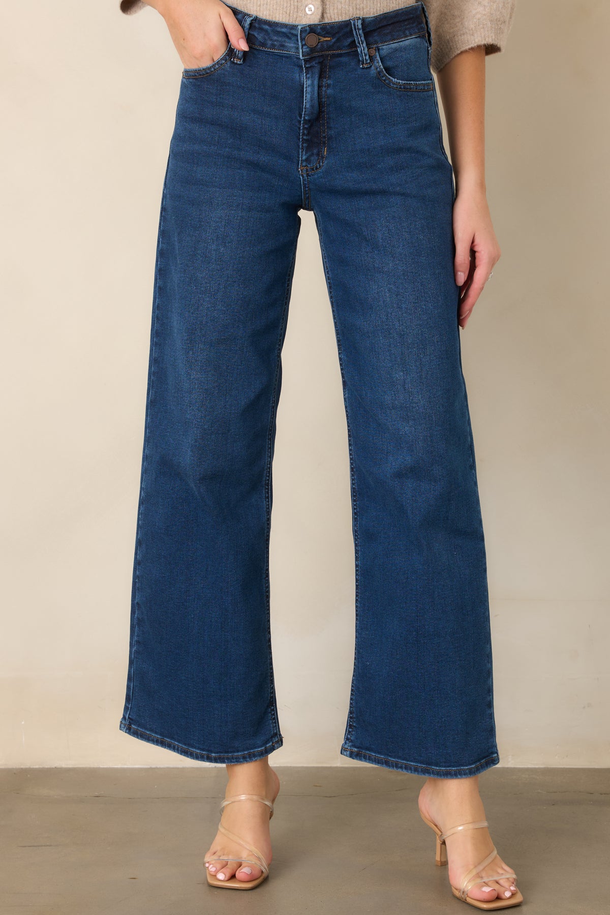 Dark wash denim showcasing the high-rise waist and classic five-pocket styling.