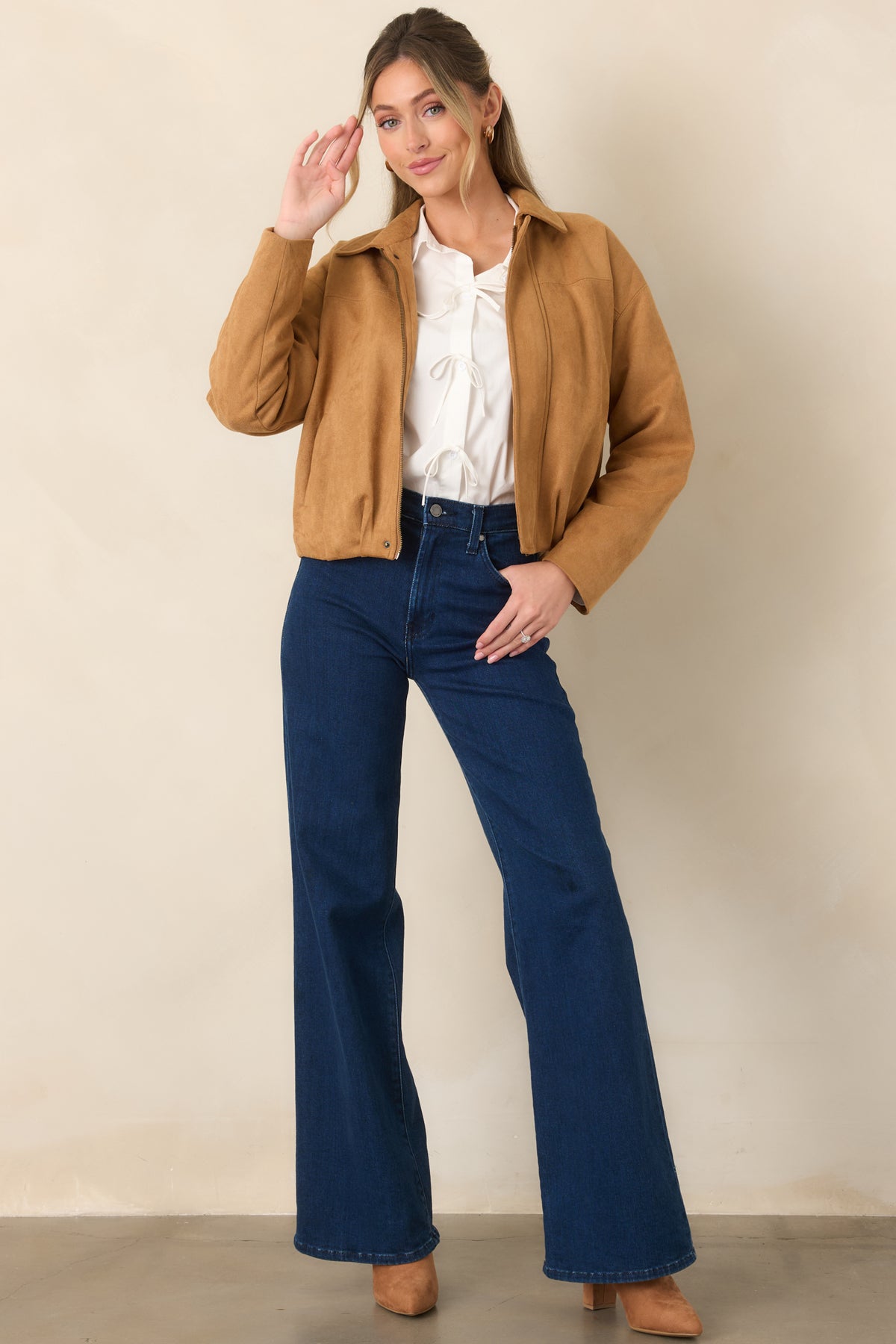 Dark wash jeans featuring a high-rise waist, wide-leg silhouette, functional front and back pockets, and classic zipper and button closure.
