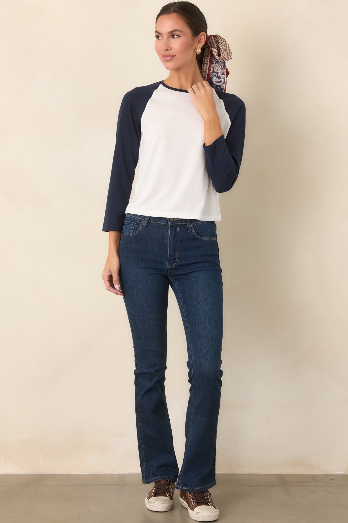 Dark wash denim jeans with a high-rise waist, slight flare leg, and classic five-pocket styling.