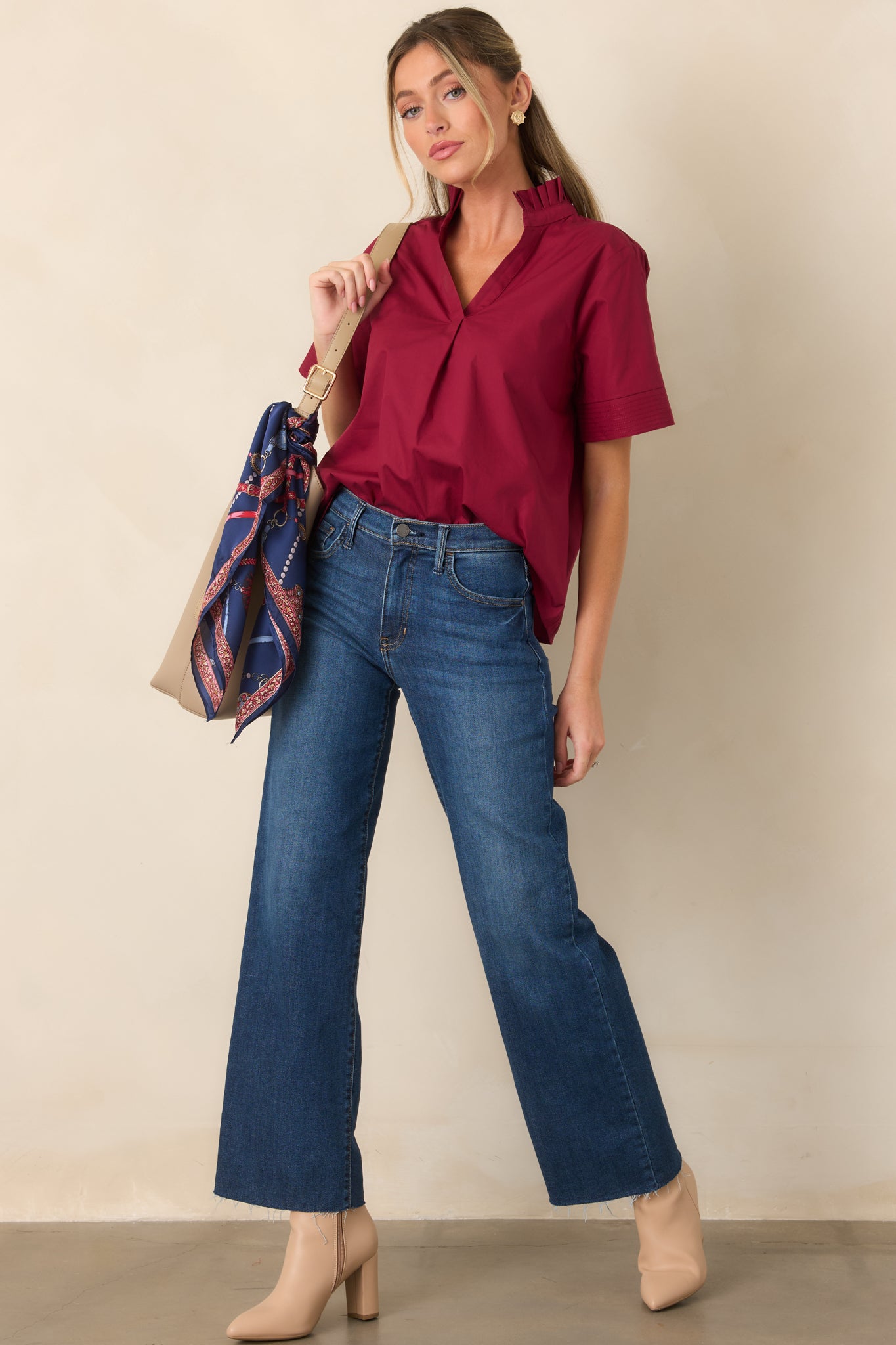 Dark wash jeans featuring a high-rise waist, straight-leg cut, functional belt loops, and classic five-pocket styling.