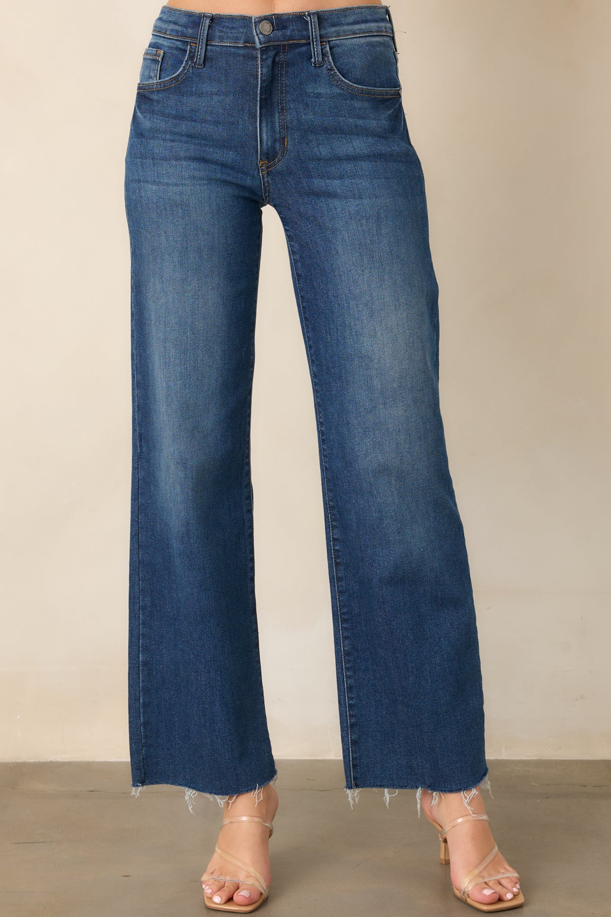Dark wash straight-leg jeans highlighting the high waist and functional belt loops along the waistband.