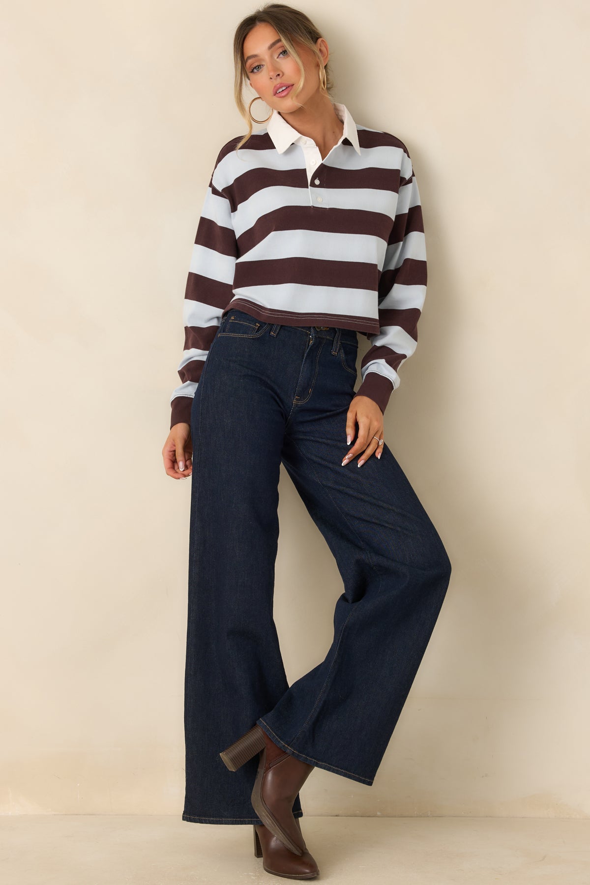 Dark wash jeans featuring a flattering high-rise waist and modern wide-leg silhouette.