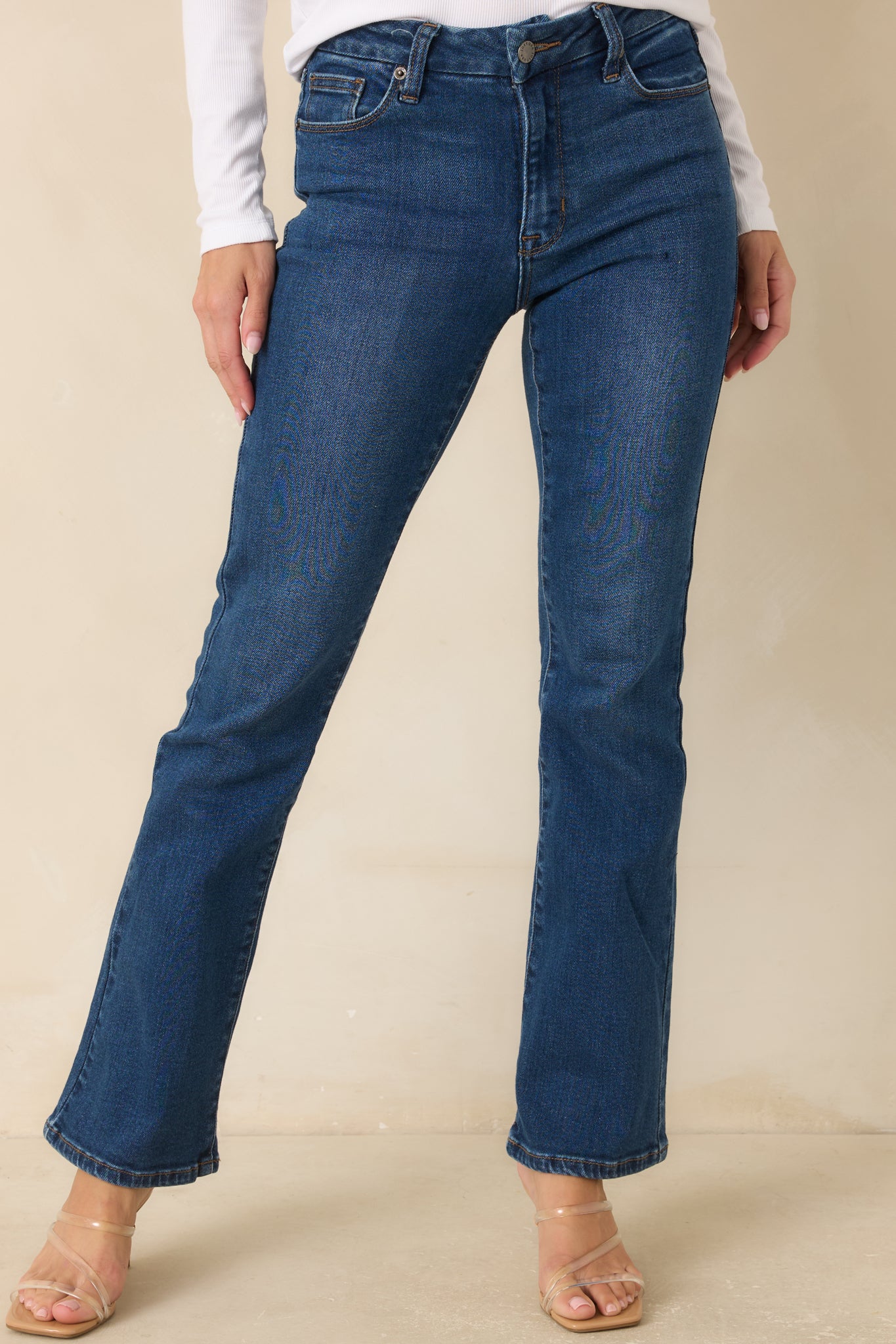Dark wash jeans showcasing the zipper button closure, pocket stitching, and timeless denim design.