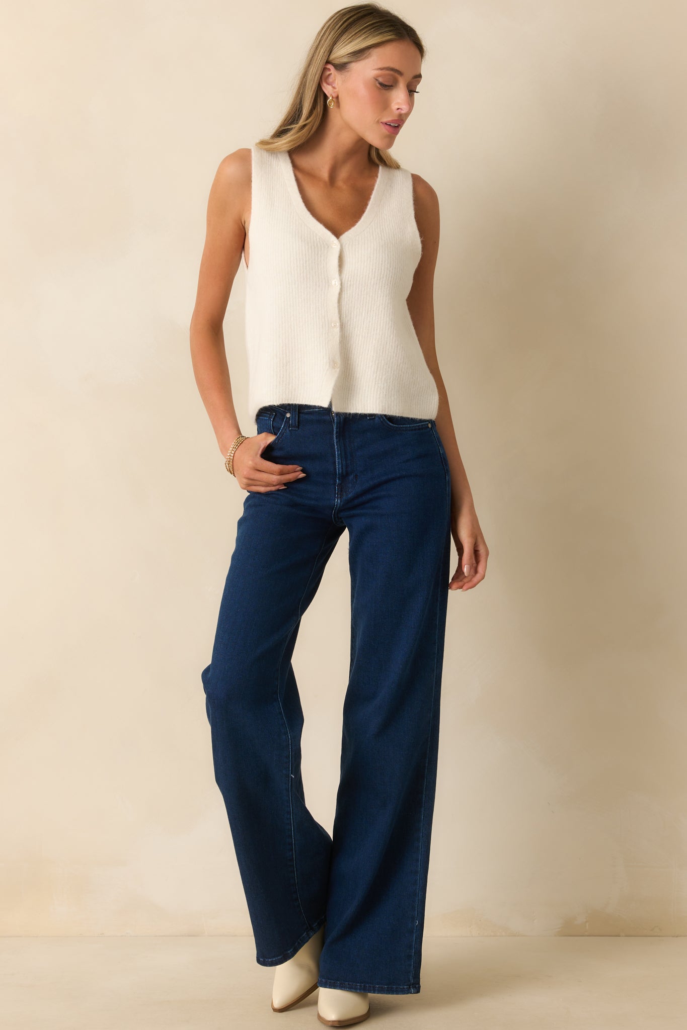 Dark wash pants highlighting the clean lines, high waist, and casual fit.